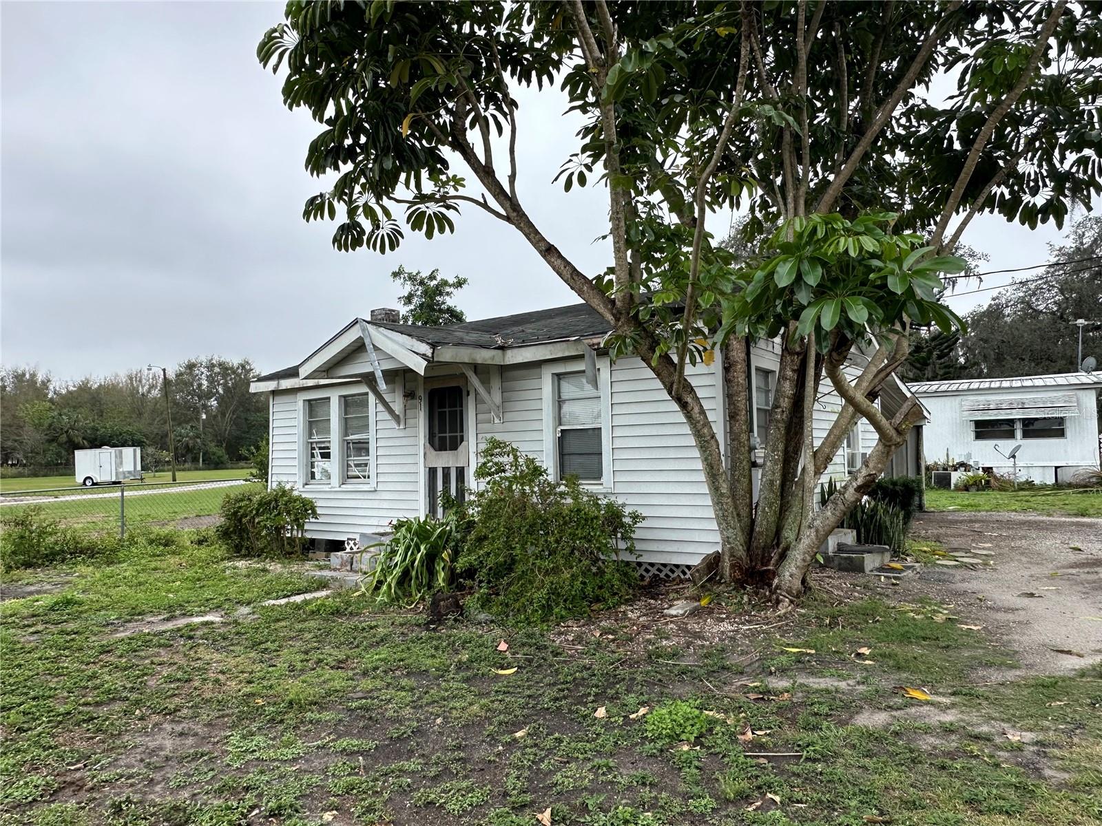 Motivated Seller! This investment opportunity features three homes on over half an acre, offering excellent potential for growth. The property includes two single-family homes, each with 2 bedrooms and 1 bathroom, and a mobile home with 3 bedrooms and 2 bathrooms. Located near the Polk Parkway for easy commuting, this property offers room for future rent increases, making it a great choice for investors seeking long-term returns.