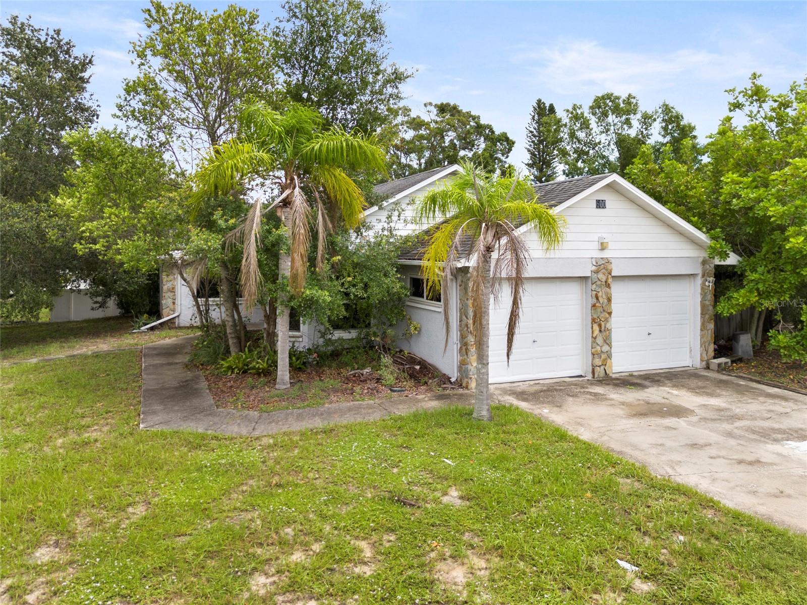 Located in a quiet and established area of Tarpon Springs, this three-bedroom, two-bath home with a two-car garage sits on a spacious corner lot shaded by mature trees. It’s being offered below market value to allow room for updates and personal touches, making it an ideal opportunity for a first-time buyer ready to create their dream home.
The layout features a generously sized living room with vaulted ceilings and a wood-burning stone fireplace, offering a cozy focal point with plenty of natural light throughout. The kitchen is well laid out with granite countertops, solid wood cabinetry, and stainless steel appliances, including a side-by-side refrigerator and dishwasher. A charming bay window in the dining area overlooks the front yard, creating a bright and inviting space for meals or morning coffee.
The split-bedroom floor plan offers privacy, with the primary bedroom tucked away at the rear of the home. This suite includes a walk-in closet and an en suite bath. Two additional bedrooms are located on the opposite side of the home along with a full bath in the hallway. A bonus room just off the living area provides flexibility as a home office, playroom, or creative space.
The laundry room is conveniently located indoors between the kitchen and garage. The oversized driveway, fenced backyard, and spacious garage offer added functionality, while the home's location outside of a flood zone keeps insurance costs manageable.
This home needs cosmetic updates and some TLC, but the potential is clear. With solid construction, a practical layout, and a peaceful location just minutes from Tarpon Springs’ historic Sponge Docks, local beaches, and downtown attractions, this is a chance to own a home with both character and value.
