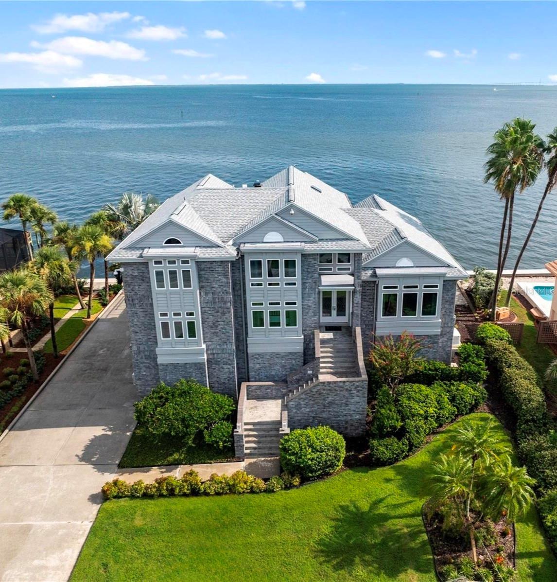 Your Waterfront Dream Awaits in Key Royale!
Welcome to your private oasis, where luxury meets the serene beauty of views of Tampa Bay ,St Pete and Egmont key state park! This isn’t just a home—it’s a lifestyle, meticulously crafted for those who crave elegance, comfort, and breathtaking views. From the moment you arrive, you'll be captivated by this stunning 4-bedroom, 3.5-bathroom property, where every detail has been thoughtfully designed, with double sea walls and a whole house generator, youll be all set, in addition this home has never flooded.
Step inside and be greeted by an expansive, open-concept floor plan with soaring ceilings and a complete wall of oversized, impact-resistant windows and sliders. These windows don't just protect—they offer a continuous, panoramic spectacle of the bay, kept perfectly clear with their own built-in washers on the living room! You'll enjoy the best of both worlds with canal views from the front dining room and bedroom, while the rest of the home provides endless, majestic vistas of the bay.
This home has been impeccably maintained and updated structually with a complete frontal redesign. The elegant brick exterior and lush, colorful landscaping create incredible curb appeal, while the interior boasts a seamless blend of refined sophistication and cozy comfort.
Take the grand staircase or the convenient elevator to the top floor, where your private master retreat awaits. This incredible suite features an additional seating area, a mini kitchen, and a private balcony where you can start your day with a hot cup of coffee and endless bay views, the huge walk-in closet and enormous bathroom with dual sinks, a luxurious soaking tub, and a spacious walk-in shower will make you feel like you'll never want to leave your own personal spa.
There is a further 3 sizable guest bedrooms with water views,a den and office should you wish to work from home as leaving here will be hard to do.
Outside, the fun continues! Fish right off your private dock, soak up the sun on the large sundeck, or take a refreshing dip in the pool. Watch dolphins, manatees, and pelicans play in the water as you relax in the screened-in lanai, perfect for entertaining guests with its comfortable seating and dining areas. As night falls, witness the spectacular light show from the Sunshine Skyway Bridge—a truly magical experience.
Calling all collectors and hobbyists! This home offers a massive 8-car garage with its own central AC unit, multiple storage rooms, and hanging racks—providing endless space for all your cars, golf carts, RV and water toys. The extremely long driveway ensures there's always plenty of room for guests.
Located in the unparralleled Key Royale community, you'll have access to a wealth of amenities, including a golf course, tennis and a clubhouse, and beautiful beaches just five minutes away.
This one-of-a-kind gem won't last long. It’s more than a house—it’s the Florida dream you've been searching for. Schedule your private showing today and prepare to fall in love!