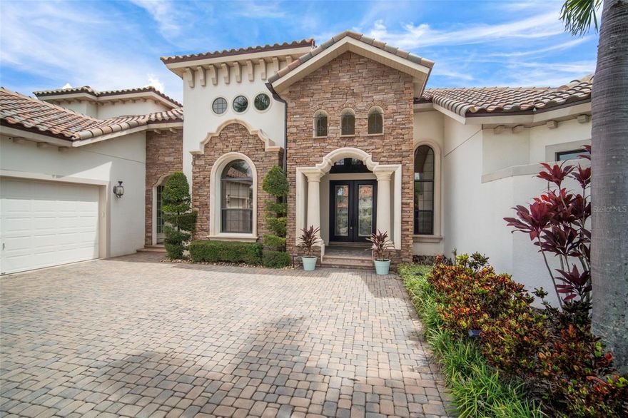 Exquisite Waterfront Estate | 200' of Shoreline..
Brand New Tile Roof (2025)..

Experience premier coastal living in this stunning John Cannon custom estate, situated on a sprawling cul-de-sac lot with approximately 200 feet of water frontage. This property offers direct lagoon access via a private dock and a 20,000 pound boat lift, making it a true standout,  in the Bay Estates of MiraBay.

Elegant Updates & Design
This primarily single-story floor plan has recent upgrades include a new HVAC system, tankless water heater, pool heater, and designer lighting.

Chef’s Kitchen: Equipped with top-tier appliances, quartz countertops, custom cabinetry, an oversized island, and a sunny breakfast nook.

Indoor-Outdoor Flow: The family room features fully retractable pocket sliding doors that open to the lanai for a seamless transition to the waterfront breeze.

Dedicated Work & Social Spaces: Includes a private home office, formal dining and living rooms, and a custom entertaining bar with integrated wine storage.

Versatile Living Spaces...
The thoughtful split-plan layout ensures privacy and comfort for all:

Primary Suite: A sanctuary featuring a sitting area, direct pool access, an oversized soaking tub, a signature walk-in shower, and custom-organized closets.

Guest Accommodations: Two additional first-floor bedrooms (one ensuite) and a pool bath with direct lanai access.

Upper Level: A remodeled guest suite with a full bath and a spacious bonus room that opens to a private balcony with sweeping lagoon views.

Outdoor Oasis
The backyard is designed for relaxation and recreation, anchored by a heated pool and spa with elegant travertine decking. The outdoor living area is completed by:

A large, spacious, outdoor kitchen and covered dining area.

A cozy fireplace and professional, lush landscaping.

Unobstructed views of the water for enjoying evening sunsets.

Additional Highlights
Custom closet systems and architectural tray ceilings.

3-car garage with epoxy flooring and upgraded storage.

Located within the gated MiraBay community, offering resort-style amenities including a clubhouse, fitness center, and community pools.Residents enjoy a clubhouse, resort-style pool, fitness center, tennis courts, parks, playgrounds, and a community boat lift allowing lagoon vessels up to 35 feet to access Tampa Bay. This resort-style community has a community clubhouse, heated-resort-style Olympic swimming pool, 136 ft water slide, parks, 3 playgrounds, gym, cafe with a full liquor license, basketball courts, tennis courts, fitness center, 135-acre lagoon where you can rent kayaks and paddle away, and much, much more. You will feel like you’re living in a 5-star resort! This community has it all. This home is centrally located and convenient to Tampa, Orlando, Bradenton, Sarasota, and St. Petersburg where you can experience the best Florida beaches, shopping, and entertainment. The Florida lifestyle you've been dreaming of awaits you. Paradise awaits! Call today for your private showing.