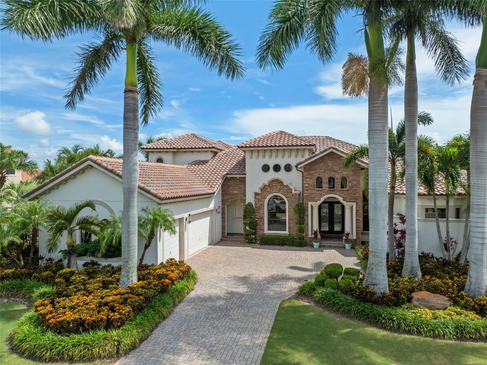 Exquisitely Updated Waterfront Estate in MiraBay’s impressive Bay Estates
Experience the ultimate in Florida waterfront living with this stunning John Cannon custom home, perfectly positioned on a private cul-de-sac lot with approximately 200 feet of water frontage. Complete with a private dock and boat lift, this estate offers direct access to the lagoon and the best of the MiraBay lifestyle.
Designed primarily as a single-story home, the layout blends elegance and livability. A long list of updates includes a new tile roof, new HVAC, new tankless water heater, new pool heater, wood flooring, designer lighting, and updated baths.
At the heart of the home is a chef’s kitchen featuring top-of-the-line appliances, quartz countertops, custom cabinetry, an oversized island with seating, and a breakfast nook. The adjoining family room brings the outdoors in with fully retractable pocket sliding doors, opening to the lanai for seamless indoor-outdoor living.
The first floor offers a thoughtful split-bedroom design:
• A luxurious primary suite with sitting area, direct pool access, spa-style bath with oversized soaking tub, signature walk-in shower, and custom closets.
• A full guest suite with its own private bath.
• A third bedroom and a pool bath with direct lanai access, perfect for effortless entertaining and convenience.
Formal living and dining rooms, plus a custom entertaining bar with wine storage, make hosting gatherings a delight.
Upstairs, a remodeled guest suite with bath, spacious bonus room, and balcony provide privacy, comfort, and sweeping water views.
The backyard oasis is truly exceptional. A resort-style heated pool and spa with travertine decking anchor the outdoor living space, complemented by a newly updated outdoor kitchen, covered dining area, cozy fireplace, extensive professional landscaping. Here, every evening feels special—whether you’re relaxing by the pool or taking in amazing sunsets over the lagoon.
Additional features include:
• Private office and wine closet
• Custom closet systems
• Tray ceilings
• 2-car garage with epoxy floors and storage upgrades
Living in MiraBay means more than just a home, it’s a lifestyle.
This rare estate offers the perfect balance of luxury, comfort, and waterfront living—all set on one of the most sought-after cul-de-sacs lots in Bay Estates. As a resident of this gated resort-style coastal community, you will feel like you are on vacation every day. This home is located in the Beautiful waterfront, resort-style community of MiraBay!!!! Residents enjoy a clubhouse, resort-style pool, fitness center, tennis courts, parks, playgrounds, and a community boat lift allowing lagoon vessels up to 35 feet to access Tampa Bay. This resort-style community has a community clubhouse, heated-resort-style Olympic swimming pool, 136 ft water slide, parks, 3 playgrounds, gym, cafe with a full liquor license, basketball courts, tennis courts, fitness center, 135-acre lagoon where you can rent kayaks and paddle away, and much, much more. You will feel like you’re living in a 5-star resort! This community has it all. This home is centrally located and convenient to Tampa, Orlando, Bradenton, Sarasota, and St. Petersburg where you can experience the best Florida beaches, shopping, and entertainment. The Florida lifestyle you've been dreaming of awaits you. Paradise awaits! Call today for your private showing.