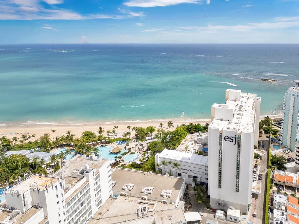This is the place if you plan to live or invest in Puerto Rico. Beautiful modern feel studio with private patio that connects directly to the pool (pool is currently in remodel phase) and beach access. This Resort Style Feel 1B/1B studio offers more than tropical scenery. A hidden treasure that includes 24/7 security, lobby, bar, fitness center, game room, coffee shop with mini market, and concierge services, making this a perfect investment property for short-term rentals. Excellent location in the hottest spot of Isla Verde near the best hotels, beautiful beaches, airport, nightlife, shopping, and dining. One of the hottest spots of tourism on the island! This unit offers the facility to include all amenities and appliances, and all you may need for a perfect vacation in the same building. No parking included.
Appliances Included: Refrigerator, Stove, Microwave, Extractor, Freezer, Air Conditioners 1 Split Unit. Furniture Included: Beds, Chess, Chairs, Dining Table, Nightstand, Futon sofa. Facilities: Elevator, Bar, Gym, 24-hour Security, Generator.