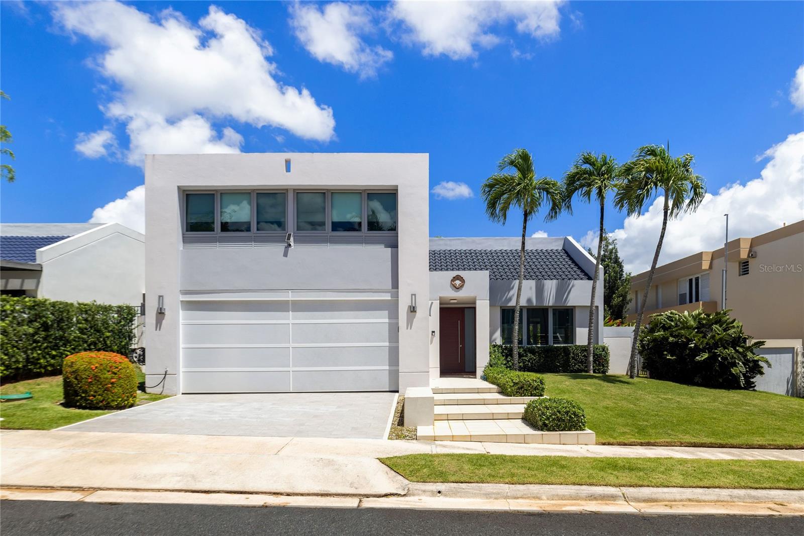 Enjoy the security and comfort of this move-in ready home located in one of Guaynabo’s most exclusive double-gated communities with 24/7 security. Featuring 4 bedrooms and 2.5 bathrooms across 2,727 sq. ft. of construction on a 600 sq. mt. lot, this property offers the perfect combination of space, convenience, and premium features. The interiors have been thoughtfully upgraded with a remodeled kitchen equipped with brand-new stainless steel appliances, modernized bathrooms, a laundry room, and a primary suite with walk-in closet. Comfort is further enhanced with 6 split-unit air conditioners, a 2-car garage, and a private pool with terrace designed for outdoor living.
This home is also packed with energy-efficient and backup systems, including 42 solar panels with 3 Tesla batteries (10KW each) which are already paid, an EV charger, a solar water heater, a 200-gallon water cistern, and a full 30K diesel generator, ensuring reliability and sustainability. Residents enjoy the benefits of a family-friendly neighborhood with tennis courts, beach tennis, pickleball court, a playground and much more, along with the convenience of being near top-rated schools and major highways. This turnkey property provides modern living in a secure and highly desirable location.