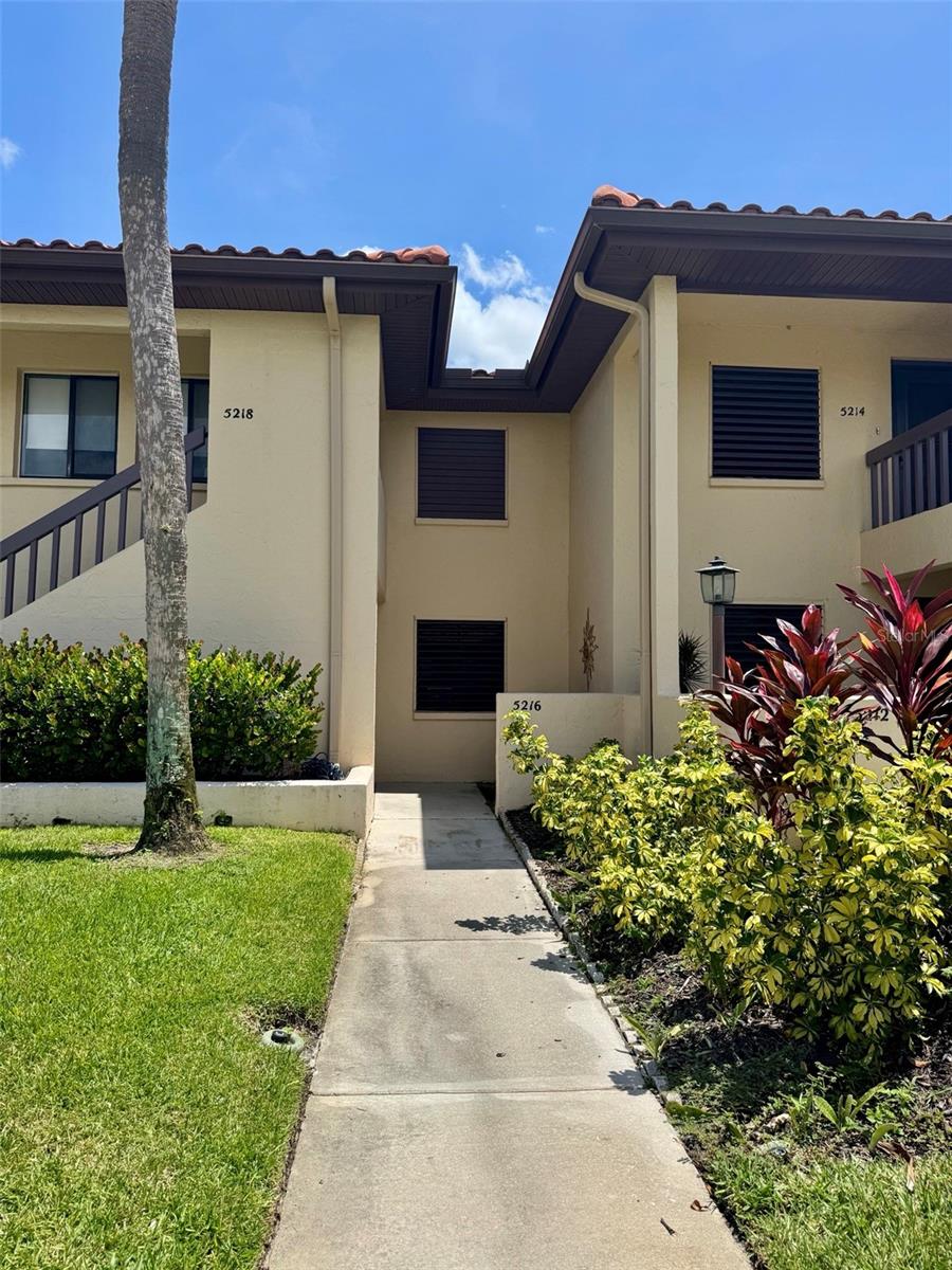 Available Now! This charming, turnkey-furnished 2-bedroom, 2-bathroom condo on the GROUND floor in the Meadows is ready for immediate occupancy for 12-month lease. Recently updated, the condo features laminate wood flooring, tile in the kitchen and bathrooms, elegant maple-colored cabinetry, and a touch of Key West-style countertops in the kitchen. Ceiling fans are installed in both bedrooms and the glassed Florida room, which also includes electric window shades. The split bedroom layout provides privacy for you and your guests, each with their own ensuite bathroom. Enjoy serene views of the lake and pool from this peaceful retreat, which also boasts a new natural gas BBQ grill area by the pool. This property is not located in a flood zone and is small dog-friendly (subject to owner and association approval), plus there's a community dog park. Property features include a walk-in laundry room with a stacked washer/dryer and well-appointed furnishings. The primary bedroom features a king-size bed, while the guest bedroom has a queen-size bed. Additional items such as games, dishes, pots and pans, two TVs, and all necessary appliances for daily living are included. The condo comes with assigned parking and guest parking available. Conveniently located within walking distance of Meadows Village Shops, residents can enjoy dining, a spa, massage services, and medical offices. This rental is exclusively for long-term occupancy (not available for seasonal or short-term rentals). A deposit equal to one month's rent is required, along with tenant application fees and approval (a two-step application process). Tenants are responsible for water, electricity, and cable. The landlord may require all tenants to obtain renter’s insurance. Please note that overnight parking of trucks or commercial vehicles is not permitted per association rules. The Meadows community features a variety of amenities, including walking trails, lakes, a fitness center, ten pickleball courts, a playground, a basketball court, a country club pool and hot tub, dining options, and a calendar of monthly community events, all included in the rent. Tennis is available for an additional fee. This condo allows you to move in with zero worries- everything is provided, and at a very reasonable rent value.