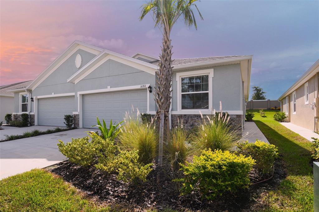 WOW ***IMPROVED PRICING *** Looking for PARADISE, just 1 block from the the*** NEW LAGOON,OPENING JUNE 24!!! Why Wait for your NEW SMART HOME. This 3-bedroom, 2 bath/2 car home is move in ready NOW. At the heart of the VERY sought after MIRADA community with a unique **15-acre man-made LAGOON by Metro Lagoons** that connects MIRANDA residents to an amazing BEACH LIFESTYLE right in their own community: swimming, kayaking, paddle boarding and PLAYING IN THE SAND is all right here just steps from your front door. MIRADA homes in San Antonio is just 5 minutes from I-75. This is a modernly designed one-story floor plan with contemporary features, ULTRAFI, ALL CONNECTED COMMUNITY and an open concept design with tile in the living and wet areas and plush carpet in the bedrooms. A two-car garage leads into the well-appointed kitchen. The covered lanai that extends the living space outdoors and provides the perfect place for relaxing. The Master bedroom also includes ENSUITE,and a walk-in closet. The split floor plan offers, two other bedrooms or a FLEX room shares a bathroom. Mirada HOA includes LAWN Maintenance, Hi Speed Internet, Cable TV . Don’t miss this beautiful VILLA! It won’t last LONG!