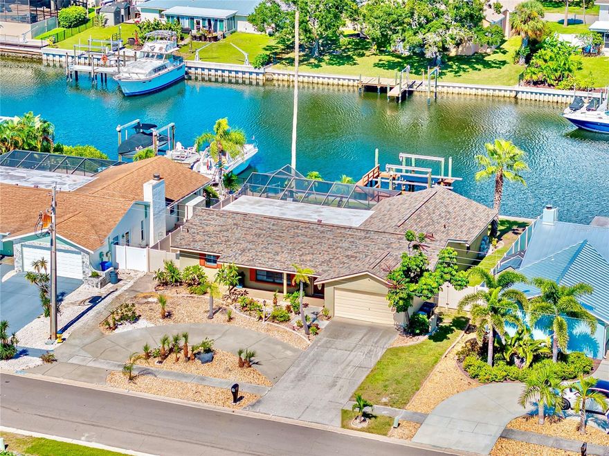 $6,000 in PRICE IMPROVEMENT! Enjoy LUXURIOUS WATERFRONT LIVING and boat parades from your backyard where outdoor recreation, boating, and sunsets meet. Situated on one of the WIDEST AND DEEPEST CANALS with direct access to Tampa Bay, this home is truly a BOATER'S DREAM, offering the largest dock on the canal and a 13,000 lb boat lift. This 4-bedroom, 2-bath, 1,930 sq. ft. waterfront residence, DESIGNED FOR RELAXATION AND ENTERTAINING, comes with NO CDD or HOA RESTRICTIONS. $130,000 IN UPGRADES ADD TREMENDOUS VALUE AND PEACE OF MIND: new SEAWALL (2025), new ROOF (2025), resurfaced pool (2025), updated HVAC system (2023), plantation shutters (2023), water heater (2022), and pool pump (2022). No interior flooding from recent hurricanes and FLOOD POLICY IS TRANSFERABLE. The large living space offers flexibility, allowing it to be turned into AN OPEN CONCEPT floor plan as well. The spacious interior features hardwood floors, pocket windows, and glass sliders that create seamless indoor-outdoor living while capturing waterfront views throughout. The bright kitchen showcases pocket sliding windows, premium stainless steel appliances and PLANTATION SHUTTERS to enhance the home with timeless style. Step outside to the OVERSIZED SCREENED LANAI and enjoy the recently RESURFACED PEBBLE-TEC POOL and new shell/coral rock pavers on the pool deck. The circular driveway, mature landscaping, and EXPANSIVE OUTDOOR SPACE set the stage for endless gatherings or quiet evenings enjoying Apollo Beach's famous BOAT PARADES right from your backyard. Perfectly located close to I-75, Tampa Airport, dining, shopping, and marinas, THIS HOME OFFERS THE IDEAL BLEND OF CONVENIENCE AND COASTAL LIVING. Live your dreams on the water - start enjoying the lifestyle you've always imagined. This dream can be yours. For investors, this home OFFERS POTENTIAL VACATION RENTAL INCOME.