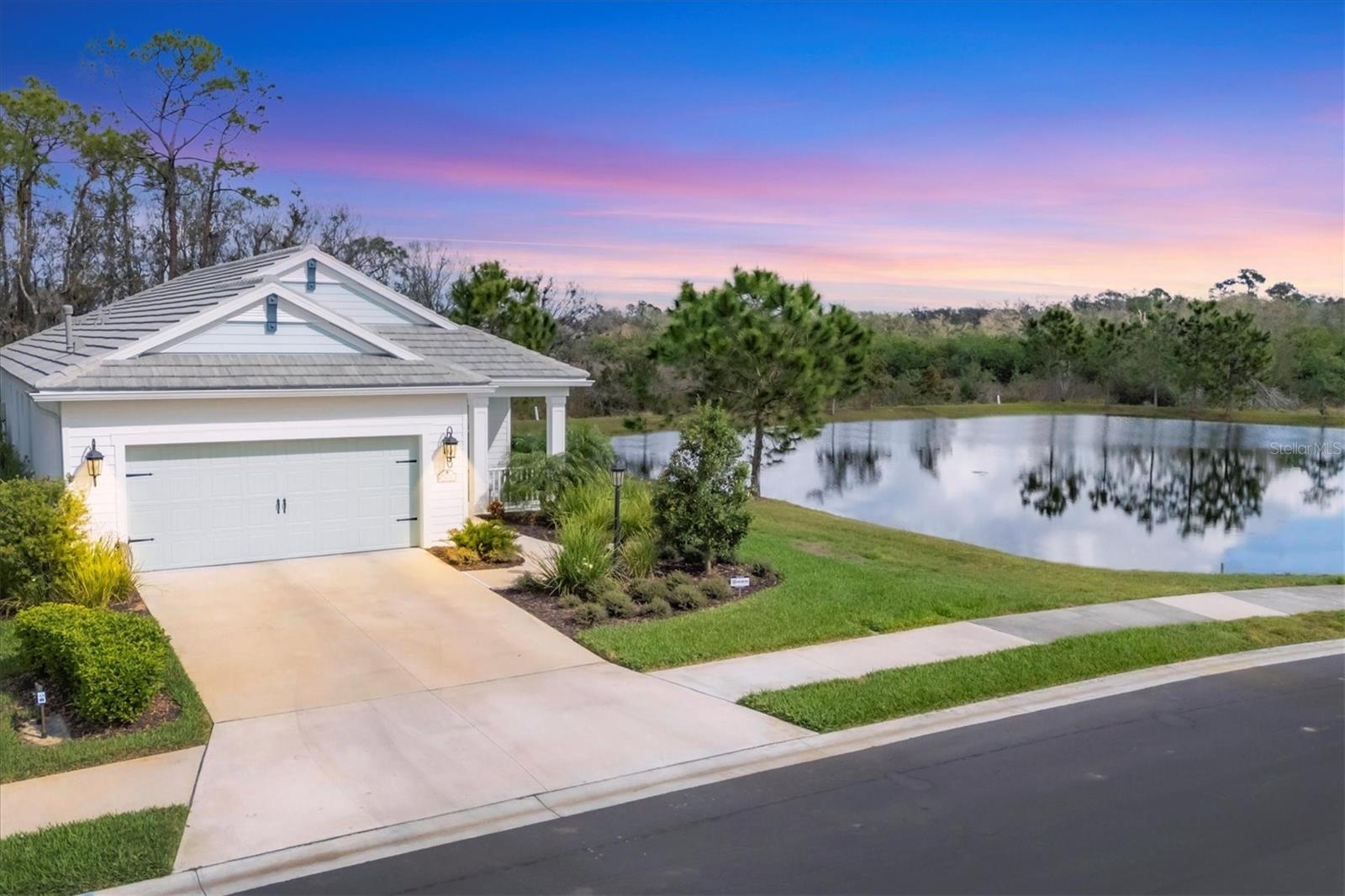 INDIGO/Lakewood Ranch, an amenity-rich gated community where you will find this beautiful "VICTORY MODEL" custom salt water POOL home situated on one of Indigo's most private lots that not only yields preserve but lake views as well! This home is also located on the quietest street in the neighborhood with little to no traffic with there being only one way in and one way out. This 2023 constructed home provides HURRICANE IMPACT windows throughout, a concrete tile roof and cinder block construction. The 2 car garage has an epoxy flake floor coating AND a HURRICANE IMPACT garage door as well! This versatile floor plan has it all with its 3 bedrooms, 2 full baths, office/den, great room, dining room, indoor laundry room, covered lanai, screened pool deck with upgraded paver flooring and 2 car garage. Enter the foyer and stroll down the vestibule as the beautiful pool and preserve views sets the stage for this beautiful home. The kitchen boasts a walk-in pantry, upgraded soft close shaker cabinetry, 5-burner gas range, stainless steel appliances, Island with breakfast bar, upgraded backsplash and premium stone countertops. All three bedrooms have walk-in closets plus a custom closet in the master, Indoor/outdoor surround sound, 5 1/4" deco baseboards, premium trey ceilings, crown molding, ceramic wood like tile, ceiling fans throughout and a whole home central vacuum system. Upon opening your three paneled sliders you will be amazed at the paver rich lanai flooring, saltwater pool with sun shelf, views of both the preserve and lake, motorized privacy screens PLUS there is a custom kitchenette with stainless steel fridge and gas grill which makes this home the ultimate Florida retreat! Indigo is a gated community that features sidewalks on both sides of the street, incredible community pool, 4 pickleball courts, 2 bocce ball courts, 24-hour exercise gym, meeting room & banquet room. Indigo is also a community that takes care of all ground maintenance to include mowing, fertilizing, irrigation, shrubs, mulching, etc. The beauty in this is that the mowing is uniformly done once a week with 6 days of silence! This home can be offered turnkey for additional cost