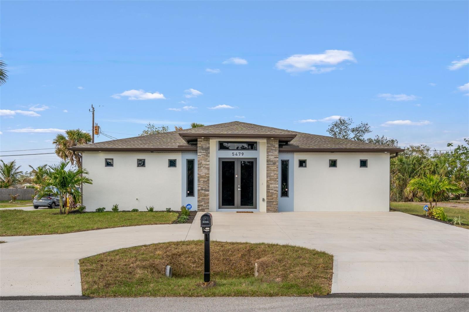 Discover an exceptional opportunity in North Port's quiet Richmar community with this brand-new, 2025 custom-built single-family home. Situated on a desirable corner lot, this expansive 4-bedroom, 4.5-bath residence is designed for comfort, privacy, and future growth. Enter a vast, family-sized living room defined by impressive 9-foot vaulted ceilings, opening directly into a chef's dream kitchen. It's equipped with gleaming stainless steel appliances, a large electric powered island, and abundant cabinet storage. Nearby, you'll find a convenient half-bath, a laundry room complete with a washer and dryer, and a versatile pantry/storage area. Enjoy consistent comfort in these main areas with a dedicated 2-ton AC unit and ceiling fan. What truly sets this home apart is the incredible privacy and amenities offered in each of the four bedrooms. Every bedroom is a private retreat, featuring its own full bathroom with a shower, a spacious walk-in closet, an individual mini-split AC unit, a ceiling fan, a minifridge, and a unique barista station with a sink. Step outside to enjoy three distinct lanais, two of which are covered, providing perfect spots for outdoor dining or unwinding. The property boasts attractive landscaping and a practical half-circle driveway. The property also includes a 10 Camera security system by Swann.