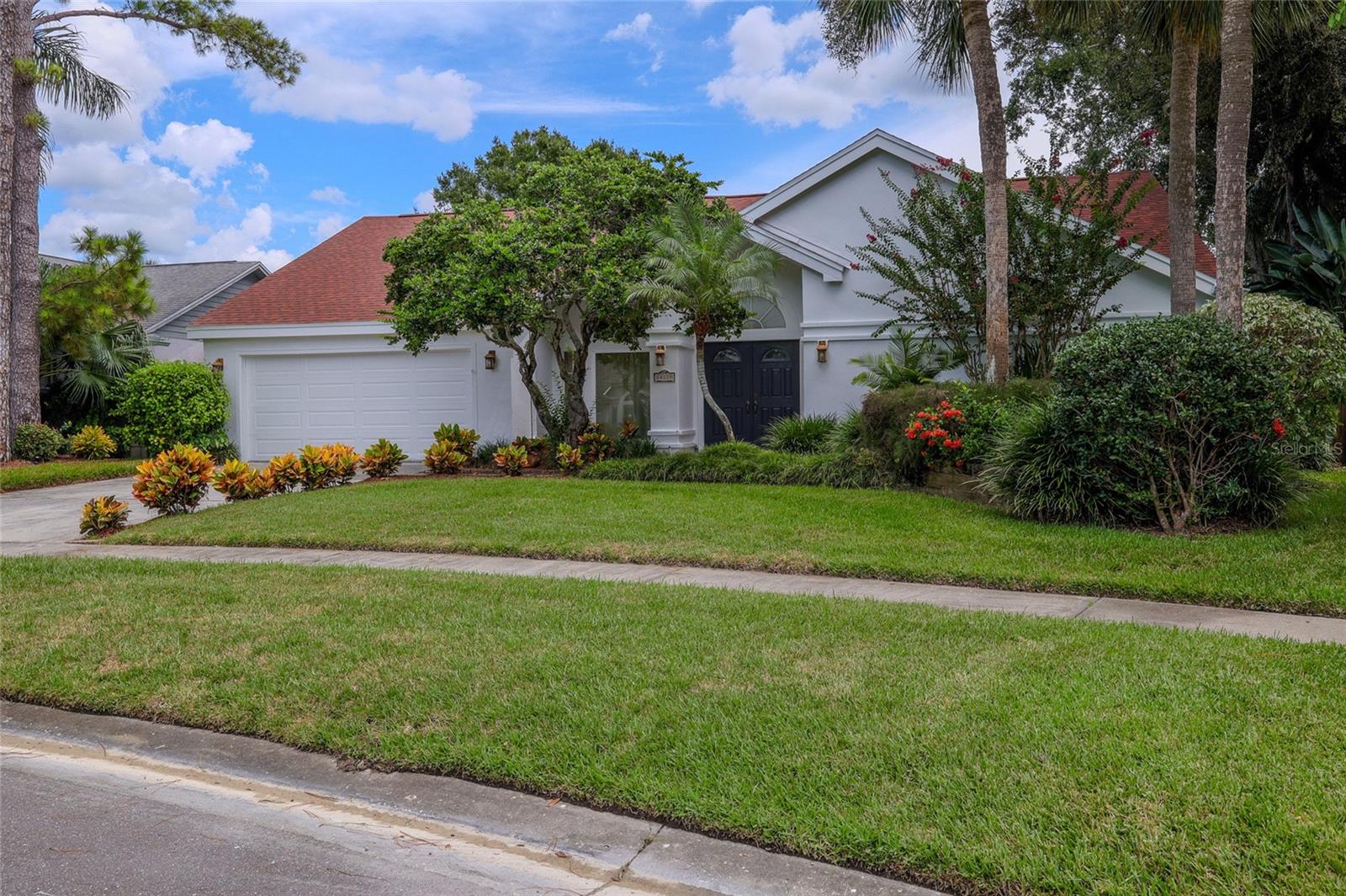 Welcome to this stunning one-story pool home featuring 4 bedrooms, 2 full baths plus 2 half baths, and a bonus Florida room, located in the desirable Stonegate community in the heart of Carrollwood! This beautifully updated home boasts numerous recent upgrades, including a new roof (2023), a new HVAC system (2024), and freshly painted interior and exterior (2025). As you step through the double doors, you’ll immediately notice the soaring ceilings and captivating view of the oversized sparkling pool and serene bass filled pond just beyond. The gourmet kitchen is an actual gathering space, featuring rich wood cabinetry, granite countertops, a large 12-foot center island with a breakfast bar, a sleek tile backsplash, and a pantry with pull-out shelving. The split floor plan ensures privacy, with the primary suite tucked away on one side of the home, offering a sense of comfort and exclusivity. The renovated, spa-like primary bathroom showcases dual granite vanities, an oversized walk-in tiled double shower, a built-in linen tower with a slide-out laundry basket, and a custom walk-in closet.
Three additional bedrooms and a well-appointed guest bath provide comfortable accommodations for family and visitors. The home also features thoughtful modern amenities, including a Ring doorbell, a Nest thermostat, a Rheem Wi-Fi-enabled water heater installed in 2021, and a water softener. The laundry room is equipped with a convenient utility sink. Enjoy Florida living year-round on the expansive screened lanai and pool deck. Take a dip in the refreshing pool, surrounded by mature landscaping, 15-foot privacy hedges, and tranquil pond views. An outdoor shower and separate pool bath offer added convenience, while an open patio area provides the perfect spot for outdoor lounging and entertaining. Carrollwood Village offers access to an array of exceptional amenities. The beautifully maintained neighborhood features landscaped grounds, sidewalks, and a vibrant calendar of community events. The nearby 21-acre Carrollwood Village Park includes an adult challenge course, walking and jogging trails, a splash pad, boardwalk, fishing pier, dog park, soccer fields, cooling fountains, tennis and pickleball courts, a skate track, and a lush arboretum—providing something for every lifestyle. Located in the heart of Tampa, this home is conveniently close to the Veterans Expressway, Dale Mabry Highway, and I-275. You're just minutes from Tampa International Airport, top hospitals including Advent Health, Bay Care, and Moffitt Cancer Center, as well as public schools and prestigious private institutions like Corbett Prep, Carrollwood Day School, and Carrollwood Country Club. Nearby, you'll also find the YMCA, JCC, great shopping, and a vast variety of restaurants and bars. Don’t miss your chance to own this move-in-ready home in one of Carrollwood’s most sought-after neighborhoods—schedule your private tour today!