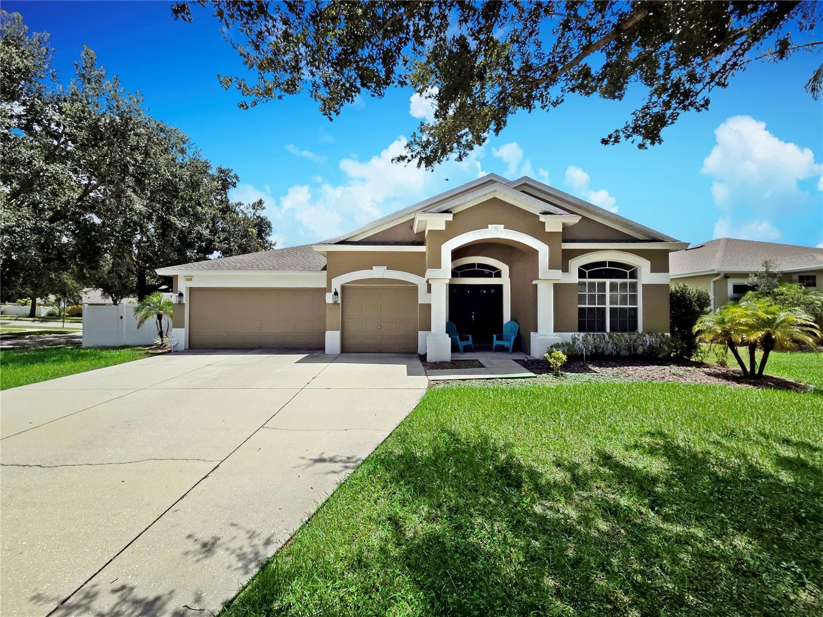 Welcome to 1906 HEARTLAND CR, a spacious 4-BEDROOM HOME WITH AN OFFICE, 2 FULL BATHROOMS, and OVER 2,500 SQ FT of living space. Sitting on an OVERSIZED CORNER LOT WITH FULL VINYL FENCING, this property offers privacy and room to spread out. The 3-CAR GARAGE provides plenty of storage, and you’ll love the LOW MONTHLY HOA DUES WITH NO CDD. A NEWER ROOF (LESS THAN 2 YEARS OLD) adds peace of mind. Inside, you’ll find NEW WOOD-LOOK WATERPROOF LUXURY VINYL FLOORING throughout the main living areas and bedrooms, with tile in all wet spaces. DOUBLE ENTRY DOORS lead to a versatile FLEX ROOM, while the private OFFICE sits behind closed doors—perfect for working from home. The KITCHEN IS THE HEART OF THIS HOME, featuring WOOD CABINETRY WITH CROWN MOLDING, CENTER PREP ISLAND, BUILT-IN DESK & CABINET NOOK, STAINLESS STEEL APPLIANCES, RECESSED LIGHTING, AND BREAKFAST AREA. It opens directly to the OVERSIZED FAMILY ROOM, creating a seamless space for everyday living and entertaining. SLIDING DOORS lead out to a SCREENED, COVERED PATIO and a LARGE BACKYARD WITH FIRE PIT—perfect for relaxing or gathering with family and friends. The MASTER SUITE offers PATIO ACCESS, DUAL VANITIES, GARDEN TUB, WALK-IN SHOWER, AND AN OVERSIZED WALK-IN CLOSET. Three additional bedrooms, each with ceiling fans and large closets, share another full POOL BATH with access to the back. The LAUNDRY ROOM INCLUDES WASHER & DRYER. The OAKS AT VALRICO is an established community in a CONVENIENT LOCATION CLOSE TO SHOPPING, DINING, SCHOOLS, AND EASY COMMUTER ROUTES INTO TAMPA.