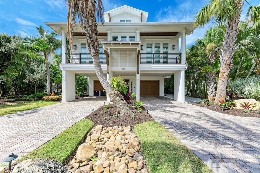 Welcome to Open Palms an intimate luxury waterfront home on one of the few canals in the City of Anna Maria with open water access with no bridges. Although zoned for weekly rentals this property has never been rented. Built by Gagne Construction with detailed design collaboration with the owners, here mentioned a partial list of all the incredible features: The dock is 50 feet long with 30-foot fixed and 20-foot floating with tide and with movable kayak/SUP board assist bar and ladder access from fixed portion. The dock is 10 feet deep and has a deployable rescue ladder to canal. The city building code changed after dock was built. Now, docks cannot exceed 20 feet in length. It includes fish light, perimeter flush-mount LED safety lights, and a power pedestal with hose bib. The Golden boat lift capacity is 14,000 pounds, with normal resting height and storm height settings, and a remote control. Owner added Swingstoppers® system for securing boat in hurricanes, canal-side ladder and catwalk installed for applying Swingstoppers. Seawall was completely replaced in 2016, including dead-man anchors to keep seawall from leaning towards canal. The home has 30 helical piers set into the lot onto which foundation bases were poured. Rebar was set into foundation bases to extend into the masonry block structural columns, which were then filled with concrete and tied to the first course of framing for floor above ground level. Wind mitigation report from construction verifies compliance with Miami-Dade standards. Fire escape ladder and platform from third floor to ground, only deployable from third floor and not accessible from ground. Propane-powered Kohler 20-kilowatt generator on third-floor landing, powers air conditioning on main floor, microwave, refrigerators, ceiling fans throughout. A 400-gallon tank runs it for 10-14 days. Three stop elevator is accessible from foyer, kitchen and sitting room. Stairs leading down to foyer/garage and from third floor have built-in pocket pet/toddler doors with rare-earth magnetic catches. Kitchen appliances include GE Profile™ 27.9-cubic-foot Smart Fingerprint Resistant four-door French-door refrigerator with door in door for quick beverage access, outside filtered water/ice dispenser, control panel, and Wi-Fi accessible status indicators. GE Profile™ microwave/oven combination with Advantium™ technology. GE Profile™ Bluetooth-enabled dishwasher and GE Profile™ 36-inch five-element, built-in touch control induction cooktop in island with GE telescopic downdraft exhaust fan that is vented to outside through basement ceiling with magnetic closing, screened vent cap to discourage infiltration of pests and water during storms. The laundry room includes Samsung smart top-load washer, including built-in sink for pre-washing delicates. Front-load dryer that is vented outside via magnetic, screened vent flap to discourage pest and water infiltration during storms. Custom stainless steel counter with sink and pulldown, two-function faucet, drying rod. Custom ceiling-height cabinets. Iron-A-Way recessed wall-mounted ironing center with task light on timer or powered off by closing cabinet door, power outlet, hot iron storage. Circuit breakers, main and generator-fed circuits, with whole-house surge suppression added. 2025 flood gates have been added to the garage doors, and all doors that lead into the property for peace of mind. Meticulously cared for and covered by Choice Home Warranty transferable to new owner.