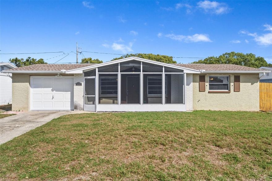 WELCOME TO YOUR SUPERB HOME at 5203 Manor Dr, New Port Richey, Pasco County, FL. This LOVELY home features 3 bedrooms, 1.5 bathrooms & 1 car garage located in a NO HOA, NO CDD & NO FLOOD ZONE. Key exterior features are long driveway, screened & covered front porch where you can meet & greet your neighbors, BEAUTIFUL front elevation with brick accents & decorative shutters, rain gutters, carriage lights, easy breezy tropical landscaping & FULLY FENCED yard. The house systems have all been replaced: AC installed 7/2018, water heater manufacture date is 5/2016 & roof installed 4/2014. The entire septic system was replaced around 2 years ago - new tank, new pipes, new leach/drain field and pumps. As you step inside, you'll LOVE the OPEN FLOOR PLAN consisting of the kitchen, dining & living rooms! The neutral color on the walls BRIGHTENS the interior while the laminate or ceramic tile floors throughout the home provide fluidity of design making the space feel larger & brighter (no carpet anywhere!). NATURAL SUNSHINE streams through the windows ILLUMINATING the house together with the various light fixtures. The RENOVATED kitchen features stainless steel appliances (range, dishwasher, disposal, microwave & French door fridge with water & ice maker), gray shaker cabinets with jet black MODERN hardware & soft-close hinges, complimentary light fixture, EXQUISITE GRANITE counters, deep double sink with gooseneck faucet, pantry & access to the garage. Create PRECIOUS memories during mealtimes in dining room featuring a ceiling fan & chair/box molding accents on the wall & then wind down in the LARGE living room. The primary bedroom can easily fit king-size furniture & has a cedarwood closet. The second bedroom also has a cedarwood closet. The 3rd bedroom features an armoire closet, wall AC unit & direct access to the backyard. This REMODELED bathroom consists of CRISP white shaker cabinet with contemporary hardware, cultured marble vanity with rectangular sink, framed mirror, built-in medicine cabinet, storage cabinet over toilet, newer toilet with bidet, gray subway tiled backsplash, towel bars, recessed lights, chair molding & combo tub/shower with safety grip handles. The second bedroom with shower & toilet is located in the garage. There is a linen closet in the hall for additional storage. In the OVERSIZED garage with newer garage door & epoxy floor, the laundry with INCLUDED WASHER & DRYER MACHINES, automatic garage door opener, attic access & side door exit are all found here. MORE SWEET features include new smoke detectors, custom blinds on some of the windows, metal rods with curtains, newer 6-panel interior doors, very nice sturdy mailbox & a big open, pavered patio in the back yard which is IDEAL for entertaining. Location is PERFECT near schools, restaurants, shopping plazas, medical facilities, places of worship, beaches & tourist attractions. MAKE THIS YOUR FUTURE HOME!