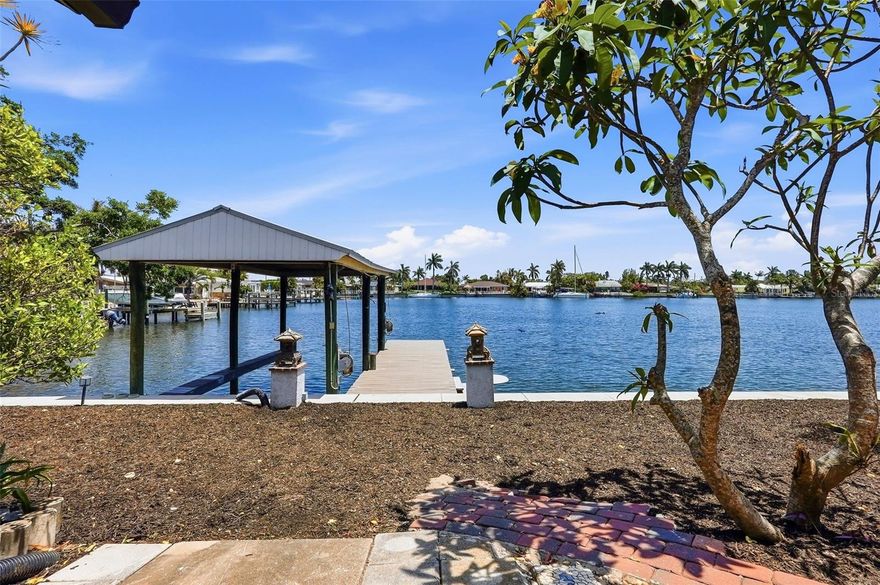 If boating is part of who you are, this home delivers the lifestyle you’ve been waiting for.
Located in the heart of Tropical Shores, this waterfront property offers what boat owners value most— immediate access (no bridges), protection, and convenience. Step outside to your rare covered Boathouse, where your vessel is shielded from the elements and ready whenever you are. No trailering, no waiting—just untie the lines and be on the water in minutes. 
From your dock, a quick cruise brings you straight to the St. Pete Pier, waterfront dining, and downtown energy—perfect for casual lunches, sunset runs, or hosting friends who arrive by water. Whether it’s a morning cruise, an afternoon on the bay, or an evening ride under the lights, the connection to the water here is effortless and seamless.
The home itself provides space to relax after a day on the water, with four bedrooms and generous living areas that invite gatherings, quiet downtime, and ready for your customization that compliments your style. Major improvements—including a new Seawall 2026, Roof 2023, HVAC 2020, Electrical panel, 2025, and Hot Water Heater 2020 —mean the essentials are already handled, allowing you to focus on enjoyment, not maintenance. The home also remained high and dry during the last storms, offering added peace of mind. 
One of the greatest advantages for a waterfront boat owner is the transferable NFIP flood insurance policy at just $2318 year, an extraordinary value that protects your investment while keeping ownership costs low. 
Beyond the dock, Tropical Shores offers a laid-back, coastal community just a short bike ride from downtown St. Petersburg’s restaurants, shops, and cultural life—plus easy access to I-275, major medical centers, and regional destinations.
This is more than a waterfront home. It’s a launch point for your lifestyle—where your boat is always ready, the water is always calling, and every day feels like the start of an adventure.