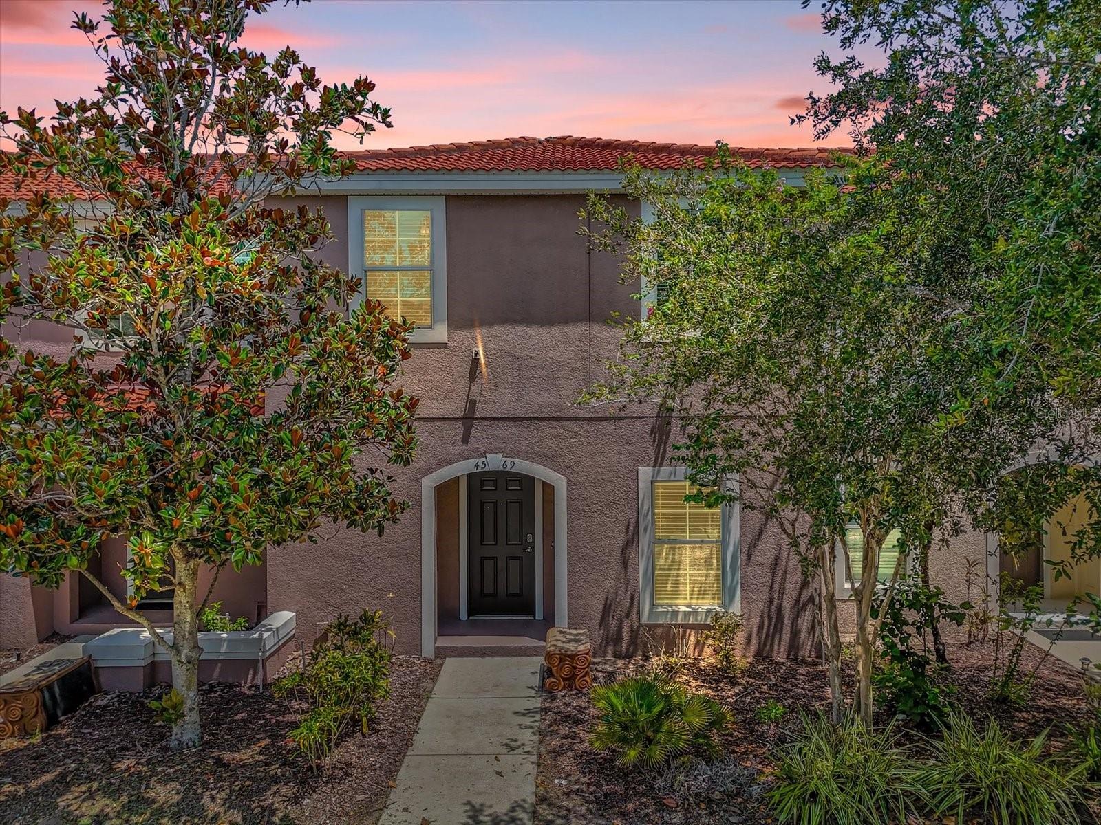 Resort-style living meets everyday comfort in this beautifully designed townhome in Bellavida, a gated, amenity-rich community just minutes from Central Florida’s top attractions. The open-concept layout on the main floor flows seamlessly from the kitchen to the living and dining areas, with sliding glass doors opening to a screened-in patio perfect for relaxing or entertaining. A convenient in-unit laundry room and half bath complete the downstairs living space.
Upstairs, retreat to the private primary suite with its own en-suite bath, while two additional bedrooms provide flexibility for guests, family, or a home office. Enjoy access to a clubhouse, fitness center, pool, playground, and 24-hour guarded security—making this an ideal choice for a vacation home, rental investment, or your own peaceful escape.