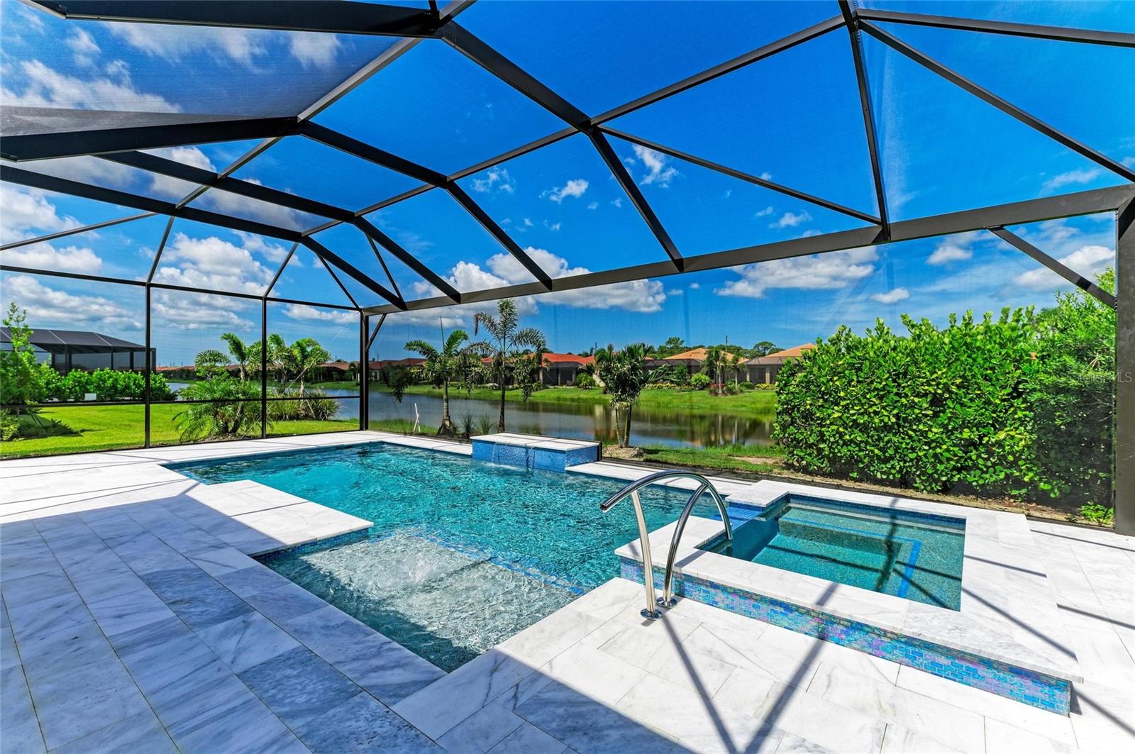 Discover the ultimate in waterfront living with this nearly new Wheaton floor plan, perfectly positioned on a desirable corner lot. This beautiful home features a brand-new luxury heated saltwater pool and a large spa, complemented by a travertine deck and a view screen, all enjoying western exposure for breathtaking Florida sunsets. The Wheaton floor plan is popular for a reason, offering an open layout that includes a great room, dining room, three spacious bedrooms, a large den, three full baths, two powder rooms (one as the pool bath!), and a generous three-car garage. Notable features include wood-look plank tile flooring throughout (no carpets here), plantation shutters, white cabinets, quartz countertops, a designer backsplash, custom closets and pantry, and designer two-tone paint reminiscent of the Florida sky. The expansive covered lanai is perfect for al fresco dining, overlooking both the pool and a serene lake while taking in stunning sunsets. Live life to the fullest year-round in Toscana Isles, a gated, resort-style, maintenance-free community designed for an active lifestyle. Engage in kayaking, canoeing, and fishing on over 200 acres of interconnected lakes right from your backyard. The 8,000-square-foot clubhouse offers a fitness center, ballroom, billiard room with a big-screen TV, and more. Toscana Isles is conveniently located just six miles from the beautiful Nokomis Beach (a mere 10-minute drive), as well as the Legacy Bike Trail and the vibrant downtown areas of Venice and Sarasota, which are rich in culture and offer exceptional shopping and gourmet dining options. Additionally, Sarasota Memorial Hospital has recently opened its new Venice campus nearby. Don't waitÂ, call today to schedule your private showing and make this dream home yours!