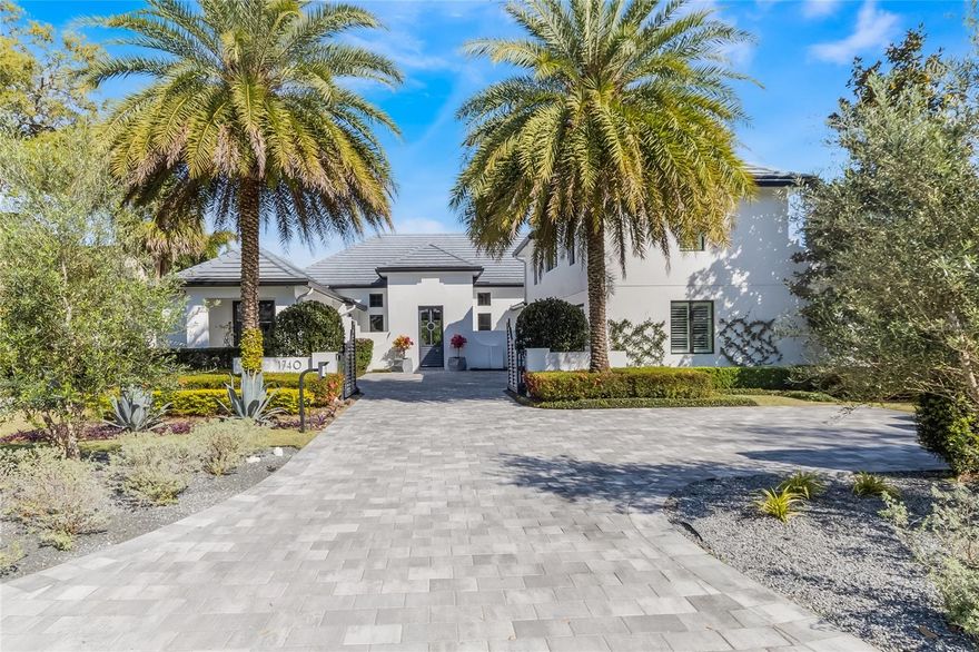 Nestled near the heart of Winter Park, this modern masterpiece exudes elegance and superb attention to detail throughout. This home was a Parade of Homes collaboration between IBK Construction & Z Properties, Inc. The entrance sequence is a showstopper including a private auto gated drive, motor court and a beautiful floating entryway with dissecting double water features on both sides. Upon entry through the extra-large front doors, you are greeted with cathedral ceilings, architectural styled beams and spacious open living areas that are light, airy and elegantly functional for both entertaining and relaxing. This area flows seamlessly to the kitchen, which is complete with double sinks, an island with walnut & marble counters and ample cabinetry with white and wood tone custom cabinetry, as well as access to the scullery for additional storage. A resplendent retreat, this is primarily a “one-level home,” which is rare to find in WP. The main-floor has 4 bedroom suites (including the owner’s suite), plus a flex room (currently used as an exercise studio). The owner’s retreat features a spacious walk-in closet and a beautiful spa-like bath with separate sinks, a makeup vanity and a free-standing tub. The 3 additional bedroom suites on the main level are split off in other locations (one is currently being used as a home office that has a private outside covered patio entry) and all separated from the owner’s suite. The upstairs area includes the 5th bedroom suite plus a lounge living area above the three-car garage. There is plenty of space to accommodate family & guests. One of the bedrooms may be used for recreation, while the office is a secluded escape for working remotely. There are walls of glass in the great room opening to an opulent outdoor lanai and tropical oasis, comprised of an outdoor kitchen, a fireplace, sufficient space for seating and a sparkling pool tucked against a backdrop of gorgeous soaring greenery. Close to the WPRC, Lake Maitland, along with being a short distance the eclectic dining and shopping of Park Avenue, this exquisite estate presents luxury living in paradise.