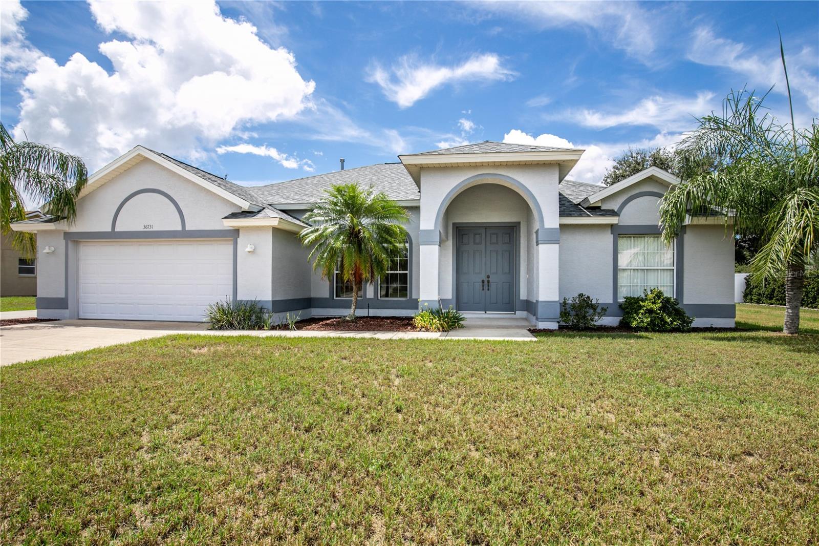 Two large garages spanning 523 SF and 400+ SF, prime location, and a home with true character! This 3-bedroom, 2-bathroom residence spans over 1,700 sq. ft. on a generous 0.37-acre lot, offering plenty of room to live, work, and play. The two well-maintained garages are perfect for vehicles, tools, and all your valuables. With its distinctive architecture, good bones, and a roof just 4 years old, this home is move-in ready yet full of potential for your personal touch. Tucked away in a quiet, friendly neighborhood, you’ll enjoy peaceful living while staying connected—just 15 minutes from downtown Mount Dora and Tavares, 7 minutes from downtown Eustis, and only 1 hour from both Orlando and Daytona Beach. Close to town, restaurants, and shopping, yet away from the hustle and bustle, this home offers the perfect blend of convenience and retreat.