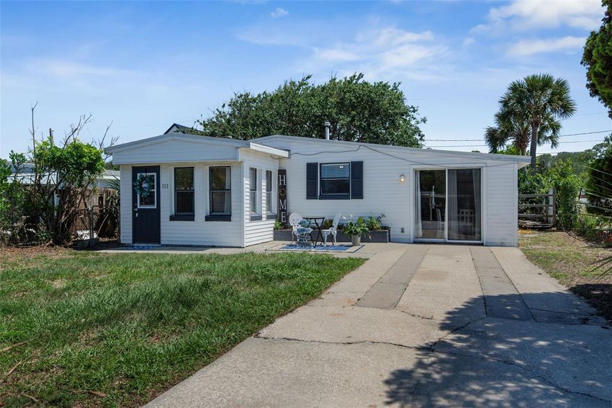 Welcome to 151 Holland Rd in beautiful Ormond Beach, Florida where coastal charm meets comfortable living just one mile from the sparkling Atlantic Ocean and public beach access at the end of the street. This adorable 3-bedroom, 2-bath home offers a unique and versatile layout featuring two separate living areas, making it ideal for multi-generational living, guests, a private owner’s suite, or even a potential second living space for added flexibility. As you enter the home, you’re welcomed by a cozy foyer/mudroom, the perfect spot to kick off your flip-flops after a relaxing day at the beach. The main portion of the home features two bedrooms, a full bathroom, a bright living room and an updated kitchen complete with beautiful butcher block countertops. Beautiful wood-look tile flooring flows throughout the home, adding a warm coastal feel while offering durability and easy maintenance perfect for beachside living. Separated by a private door off the kitchen, the additional living space offers a spacious living and dining room combination, a full bathroom with a stunning tiled shower and a private bedroom tucked away in the rear of the home. Step outside and enjoy the Florida lifestyle with a large covered, screened-in back patio overlooking a private fenced in backyard. Complete with an additional storage shed perfect for beach gear, tools, or extra storage needs. This home can also be sold partially furnished, making it an excellent option for a second home, vacation retreat or buyers looking for a move-in-ready opportunity without the hassle of purchasing new furniture. Major updates have already been completed for peace of mind, including a new roof in 2017, A/C in 2022 and water heater in 2022, making this home ideal for low-maintenance coastal living. All appliances convey, including the refrigerator, stove, washer, and dryer. If you’ve been dreaming of living near the beach without the hefty price tag, 151 Holland Rd is the perfect place to call home. Schedule your private showing today because this charming beachside property will not last long!