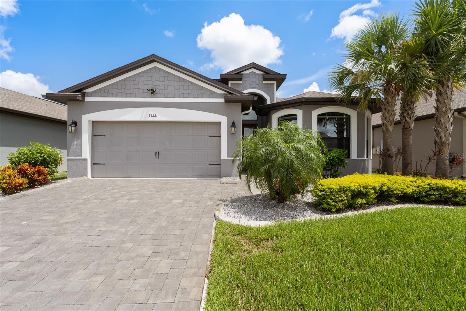 Welcome to this beautifully upgraded Vitale-built home in the desirable Watergrass community of Wesley Chapel. Offering nearly 2,500 sq ft, this 4-bedroom, 3-bathroom residence also features a versatile media room that can easily serve as a 5th bedroom or home office. Step into the heart of the home—a stunning open-concept kitchen and family room designed for both daily living and entertaining. The kitchen has been thoughtfully updated with quartz countertops, a marble backsplash, and a spacious center island perfect for gatherings. Just off the living area, is a screened-in lanai and a newly installed oversized patio with fresh landscaping that creates a serene space ideal for outdoor dining or relaxing under the beautiful Wesley Chapel sky. Enjoy modern comforts with whole-home technology upgrades, including smart switches, Wi-Fi-enabled fan, smart thermostats, Wi-Fi smart lock, and CAT 6 cabling in every room to support 10-gig high-speed wired internet—ideal for remote work, streaming, or gaming. Watergrass offers resort-style amenities including one lap pool, a zero entry pool, a third community pool, tennis courts, fitness center, a pavilion, and numerous playgrounds with one located within the neighborhood—giving you the perfect blend of luxury, lifestyle, and location. Convenience is unmatched with I-75 just minutes away and everyday essentials like Publix and Starbucks just down the street. Top-rated schools, including Watergrass Elementary, Kirkland Ranch Academy of Innovation, and Innovation Preparatory Academy, are just moments away. The home’s prime location also offers easy access to Tampa Premium Outlets, Wiregrass Mall, KRATE at the Grove, top hospitals, and an array of dining and retail options.