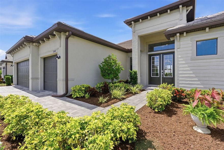 THIS PROPERTY QUALIFIES FOR A 1% LENDER INCENTIVE IF USING PREFERRED LENDER Lowest Priced Sunset floorplan, Estate Series Home (80+Ft wide lot) in Lorraine Lakes.  Welcome to Your Dream Home in the BEST RESORT STYLE LIVING COMMUNITY in LAKEWOOD RANCH! With soaring 10-foot+ ceilings and an open floor plan, it’s perfect for both everyday living and entertaining.   Enter through a grand 12-foot ceiling foyer into the expansive great room, which features a tray ceiling and FOUR glass panels leading to the spacious lanai. The GOURMET kitchen is a chef’s dream, vented hood and cast iron range with a large island that seamlessly connects to the living and dining areas. Its elegant QUARTZ countertops are as durable as they are beautiful, making it a perfect space for cooking and gathering. The split floor plan offers the ultimate in privacy. The owner’s suite is a peaceful retreat with two walk-in closets, dual square sinks, an oversized shower, and private access to the lanai. The room’s tray ceiling and spacious layout allow for a sitting area or home office. On the opposite side of the home, two additional bedrooms each have their own full baths and ample storage. The third bedroom’s ensuite bath is conveniently located for future use as a pool bath—ideal for guests. There’s also a cozy bonus room that can be used as a home office, playroom, or den, depending on your needs with solid French doors. Enjoy indoor/outdoor living with the enormous covered lainai from living room to the master bedroom. The private backyard is perfect for BBQs and football games with friends and family. At 2,650 square feet, this home provides plenty of space for comfort and luxury. Lorraine Lakes has 3 pools, 24 hour fitness center, locker room, sauna, pickle ball courts, tennis courts, putting green, beach volleyball court, playground, on-site restaurant, Event Coordinator, Complimentary Cafe station, Arcade room-no tokens needed, TRX room, Full size basketball court, social room, a mile radius of lakeview walks with workout stations, and hot tub. This home offers the perfect blend of style, space, and comfort—don’t miss out on making it yours!