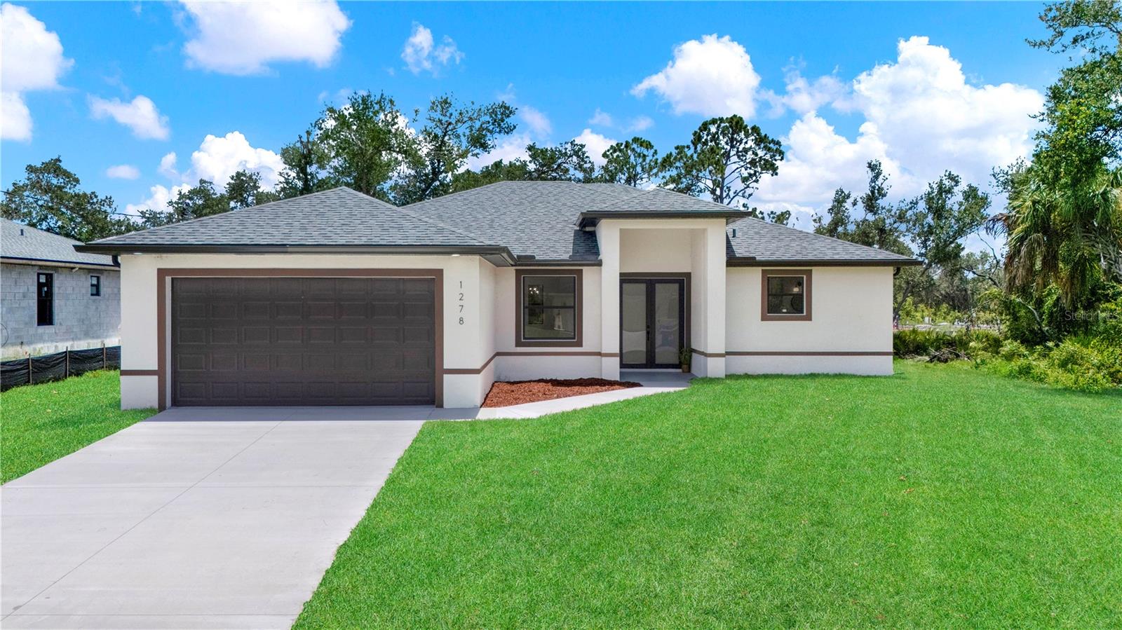 There is nothing “builder grade” about this new construction home. From the moment you walk in, you will notice the upgrades that set it apart from the typical builds nearby. Impact-rated windows and doors provide peace of mind, while a full irrigation system keeps your lawn looking great year-round. Inside, the open floor plan shines with upgraded cabinetry, stylish finishes, and thoughtful details that add comfort and value.
The primary suite offers a spacious retreat with a spa-inspired bath, and the split layout ensures privacy for guests. Every detail has been designed with both everyday living and seasonal enjoyment in mind — perfect for full-time residents or snowbirds looking for a low-maintenance Florida home.
Location matters, too. Centennial Park with its pool, recreation facilities, and community amenities is just minutes away. You will also appreciate quick access to shopping, dining, medical services, and more.
If you have toured some of the more basic new builds in the area, come see the difference. This one is move-in ready, beautifully upgraded, and waiting for its new owner. Schedule your showing today.