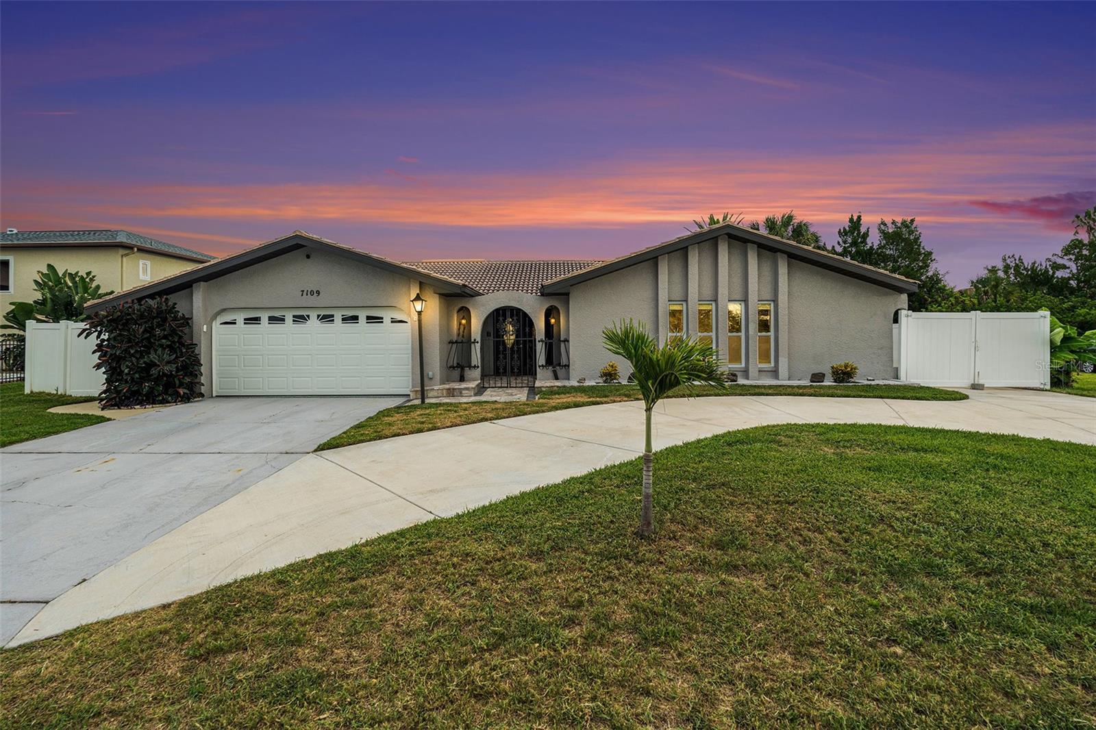 Welcome to your tropical paradise in the Sea Pines community of Hudson, a vibrant golf cart-friendly neighborhood where waterfront living meets Florida charm. This beautifully updated three-bedroom, two-bathroom pool home is situated on an extra-wide canal with direct water access, making it a dream for boaters and outdoor enthusiasts alike. Enjoy your own private dock equipped with a 10,000lb boat lift, plus an additional floating dock - perfect for launching your boat, jet ski, or kayak. The home features numerous recent upgrades including a 2024 A/C, 2025 water heater, and hurricane impact windows in most of the home, making it truly move-in ready. Curb appeal and functionality shine with a spacious circular driveway, gated parking area for up to three cars or an RV, and a newly epoxied two-car garage complete with a new door and opener. Inside, you’ll find vaulted ceilings, a cozy wood-burning fireplace, and a finished Florida room that adds 240 square feet of flexible living space. The open-concept layout includes a family room and kitchen combo, highlighted by a dry bar ideal for a coffee station or additional storage. The gourmet kitchen has been fully updated with granite countertops, stainless steel appliances, pendant lighting over the island, and plenty of cabinetry. Waterproof wood-look laminate flooring flows through the main living areas, while the bedrooms offer plush carpet with waterproof padding. The spacious primary suite features views of the pool and canal, along with a private en suite bathroom boasting a granite double vanity, newly tiled walk-in shower, and modern fixtures. The secondary bedrooms are well-sized, and the second bathroom is equally updated with granite counters, upgraded lighting, and a tiled shower with glass enclosure. Step into your private backyard oasis, complete with a screened-in in-ground pool, tropical landscaping, a pergola perfect for shaded dining, and a 4x16 shed for extra storage. The golf cart-friendly community allows you to ride to Hudson Beach with local waterfront favorites like Sam’s Beach Bar, Inn on the Gulf, The Fisherman’s Shack, and Ollie’s. Just a 5-minute ride away is SunWest Park, offering a beach and floating waterpark. A short drive takes you to Hernando Beach, and in under 25 minutes you can explore the natural beauty of Weeki Wachee Springs with its famous mermaid shows and waterslides. Combining comfort, style, and unbeatable location, this home is a rare opportunity to live the ultimate Florida lifestyle. Schedule your private showing today.