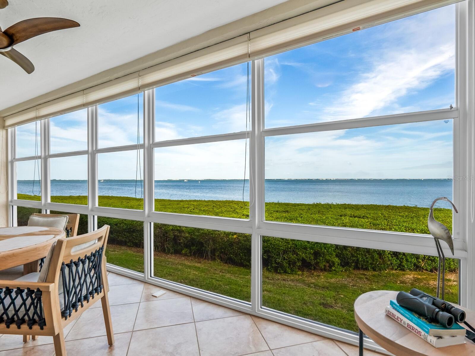 Beauty on the Bay will be found in this delightful 2 bedroom 2 bath condo at Windward Bay. In fact, one of the very few units currently on the market at Windward Bay with all assessments fully paid off, including the 15 year community capital improvement assessment and the 30 year Longboat Key Undergrounding assessment! You will immediately notice the full bay view unobscured by the many mangrove islands behind most of the buildings in Windward Bay. The photos readily show you the location of this particular building directly across from the amenity center as well as the owner's good taste used in the unit's updated interior with brand new luxury vinyl plank flooring, GE Profile double oven, Bosch stacking washer/dryer, Hunter Douglas window treatments, granite countertops and Brookhill custom wood cabinets in kitchen and baths, Honeywell Wi Fi thermostat with humidity control & Moen plumbing fixtures. Windward Bay is a low-density pet friendly community nestled on 26 acres with 1/2 a mile of waterfront trails, 3 nearby beach accesses, 2 tennis/pickleball courts, 2 marinas with 28 boat & jet ski slips for a low monthly fee (waitlist), kayak racks, 2 heated pools, shuffleboard, bike racks, a clubhouse with kitchen, library, fitness room, meeting room, 2 saunas, and two community fire pits. The property's mid key location affords you easy access to the many eateries and shopping opportunities not only on Longboat Key but also neighboring Anna Maria Island and St Armands Circle. For added security, The State of Florida Structural Integrity Phase 1 Milestone Inspection is complete and Windward Bay is certified for an additional 10 years.