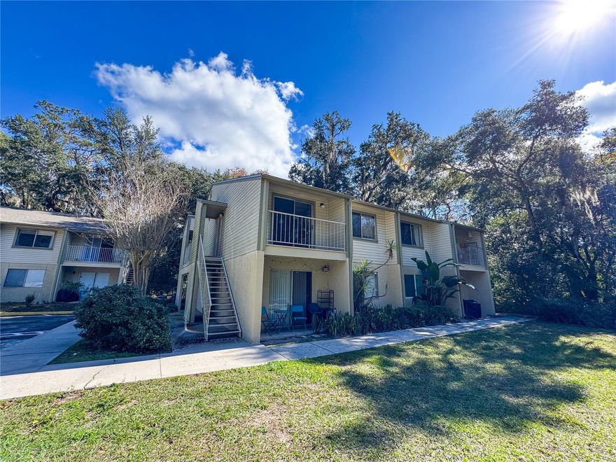 Turn-key and beautifully remodeled 1-bedroom, 1-bath top-floor corner condo in the highly sought-after Tumblin Creek community. Ideally located just three blocks from the University of Florida, the medical school, and Sorority Row, and less than one mile from Depot Park. Walk to UF undergraduate classes or hop on the nearby bike trail that connects campus and downtown, located right at the edge of the community.
Tumblin Creek offers a peaceful, wooded setting with mature trees, ample shade, and a serene creekside atmosphere. The condo features a renovated kitchen with breakfast bar, white shaker-style cabinets, stainless steel appliances, solid surface countertops and a washer/dryer. There is tile and engineered hardwood flooring throughout (no carpet) as well as a spacious bedroom with walk-in closet. The living room and bedrooms have been upgraded with ceiling fans, a must have for FL summers. Enjoy relaxing on the covered balcony, and appreciate the privacy of a top-floor unit with no neighbors above. To top it off, this is a rare unit with a washer/dryer upgrade. 
The association fee includes water, sewer, building hazard insurance, and all exterior maintenance including roof, siding, lawn care, and water. The unit also comes with parking for up to two vehicles. Priced to sell!