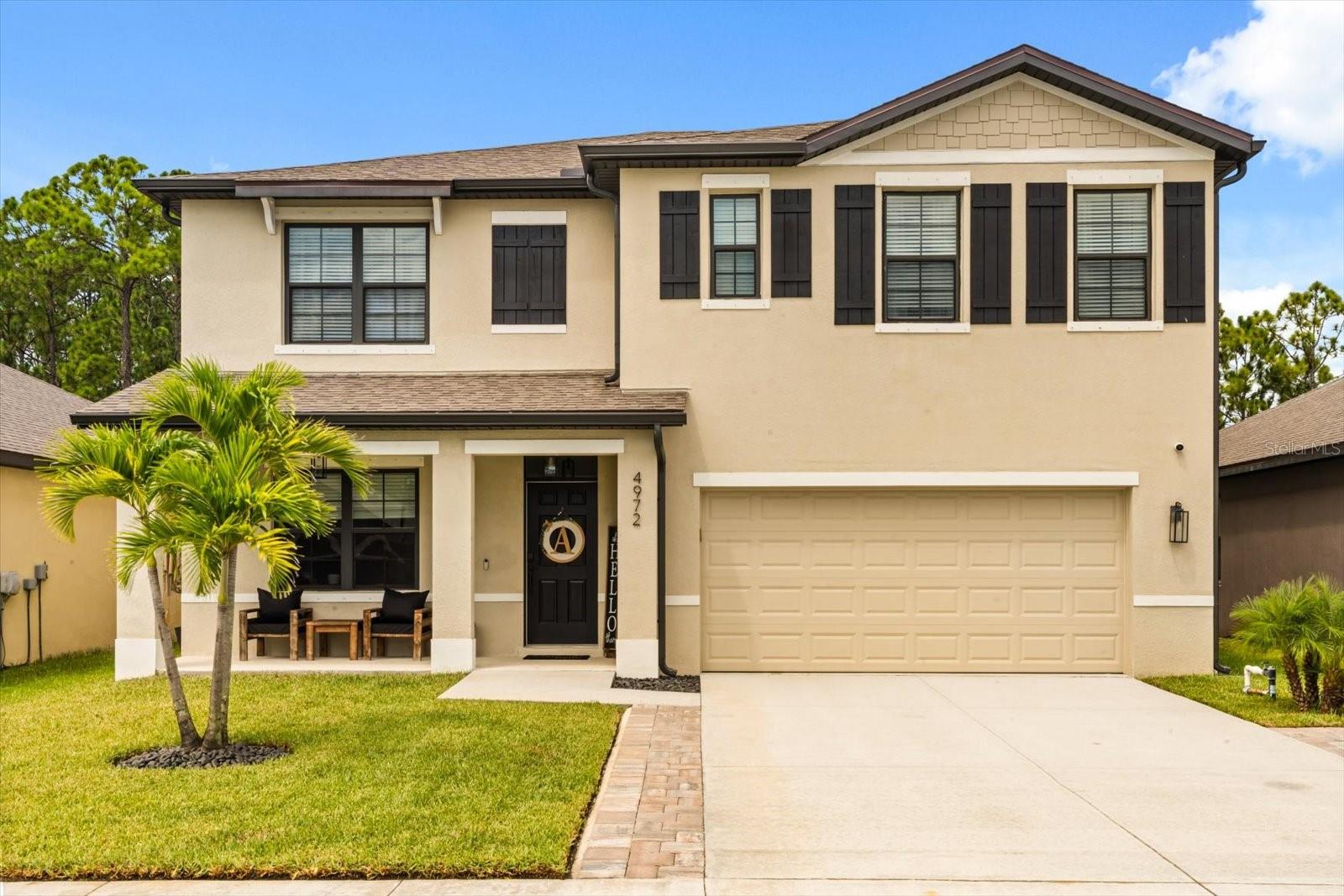 Why buy new? Because this stunning, move-in-ready 5-bedroom, 3-bath Hayden model—built in 2023—is everything you've been searching for. Located in the desirable Adamson Creek community, this spacious home offers over 2,600 sq ft of thoughtfully designed living space with a fully block exterior and upgrades that truly set it apart. Enjoy the added security and convenience of a Google™ doorbell, thermostat and full security system with exterior cameras. Entertain with ease in the fenced backyard featuring a 26' x 16' paver patio or take advantage of the front porch, expanded driveway and lush front yard that make a great first impression. Inside, you'll find an open-concept layout filled with natural light, luxury vinyl plank flooring throughout the first floor, an updated kitchen with a large island which includes a farmhouse sink and breakfast bar and stainless-steel appliances. Newer, energy-efficient systems provide peace of mind, while the fresh, modern design means no costly updates or repairs. Skip the stress of renovating—this is the perfect blend of style, function, and future-ready comfort. This home is located near I-95 just minutes from Cocoa Beach Village and Viera, shopping and dining galore! Be sure to check out the floor plan and full list of upgrades attached in the MLS!