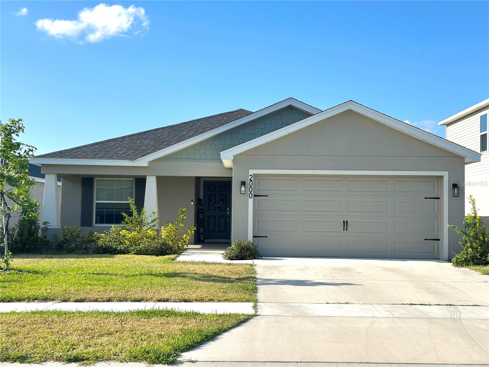One or more photo(s) has been virtually staged. This amazing home is Move in ready! No need to wait for your home to be built. You can have this Highland Homes Parsyn, only One year old home with 1,545 square feet on one-story including 3 bedrooms, 2 baths, and an open living area with high ceilings. Enjoy an open kitchen with Silestone countertops, Samsung stainless steel appliances, a walk-in pantry, and a spacious island, fully open to the dining café and gathering room. The living area, laundry room, and baths include luxury wood vinyl plank flooring, with stain-resistant carpet in the bedrooms. Your owner's suite is complete with a large walk-in wardrobe and a private en-suite bath with dual vanities, a tiled large walk in shower, and a closeted toilet. Plus, enjoy a screened covered lanai, 2-car garage, custom-fit window blinds, architectural shingles, energy-efficient insulation and windows, and a full builder warranty. Step outside to the lanai, a perfect place to enjoy Florida’s warm evenings with family and friends. The home is also backed by no rear neighbors and a beautiful view, providing added privacy and a serene atmosphere. Additionally, the professional front yard landscaping enhances the home’s curb appeal. Located just a short walk from the playground and community pool, this home is perfectly situated for families. Enjoy proximity to shopping, dining, and local attractions, as well as top-rated Polk County schools. Irrigation system in proper operational status. Low HOA here, so don't delay! Call for your private showing today!