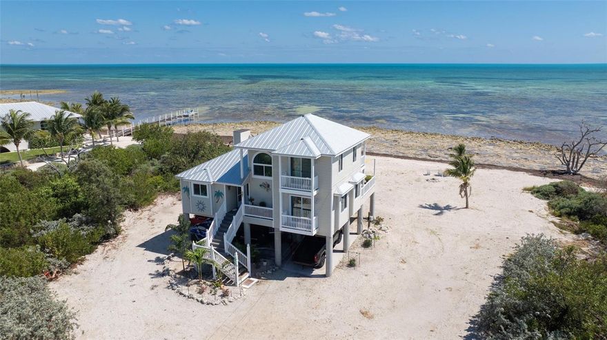 One of the only true luxury oceanfront estates with a private sandy beach available in the Florida Keys.

Live where others vacation at this breathtaking Big Pine Key oceanfront residence, gracefully positioned on over 300 feet of private shoreline along the Atlantic Ocean. Offering 1,850 sq. ft. of elevated, fully remodeled living space, this rare coastal sanctuary is the epitome of privacy, sophistication, and island luxury.

Unmatched Strength & Design
Built with enduring quality—pressure-treated lumber, 2x6 framing, and ½" plywood sheathing inside and out—this home combines resilience with refined style. Large missile-rated impact windows and exterior doors frame panoramic ocean views while providing the highest standard of protection. The newer standing seam metal roof further ensures long-term durability.

Sophisticated Interiors
Inside, you’ll find three elegantly appointed bedrooms and two designer bathrooms, each curated to embrace natural light, water views, and coastal tranquility. Refined finishes elevate every corner:

Luxury vinyl plank flooring

Designer lighting & ceiling fans

Striking LED fireplace

Bespoke kitchen with onyx waterfall countertops

Bathrooms with digital shower controls & bidet toilets

Generous closets (a rarity in the Keys), a convenient interior laundry room, and a climate-controlled workshop add both function and luxury.

Smart Home Convenience
This residence is a true smart home, offering remote access to:

Gated entry & front door lock

AC systems & select lighting

Security cameras

Electronically controlled showers

Exceptional Features
Every element of this property enhances the vacation-style lifestyle:

Newer AC units, appliances, and water heater

Fully furnished with appliances, including a commercial-grade ice maker producing 500 lbs/day—perfect for boating adventures

Spacious 24,600 sq. ft. lot bordered by government-protected land for unparalleled privacy & unobstructed views

Meticulously maintained 2020 Kubota MX5200 tractor with premium attachments ($30K+ value)

Your Own Ocean Playground
From your private beach, enjoy snorkeling, swimming, and lobster diving in your backyard waters. Nearby, explore Bahia Honda State Park, Calusa Beach, and the National Key Deer Refuge. Just under an hour from vibrant Key West and only 28 miles from Key West International Airport, you’re perfectly situated for both retreat and adventure.