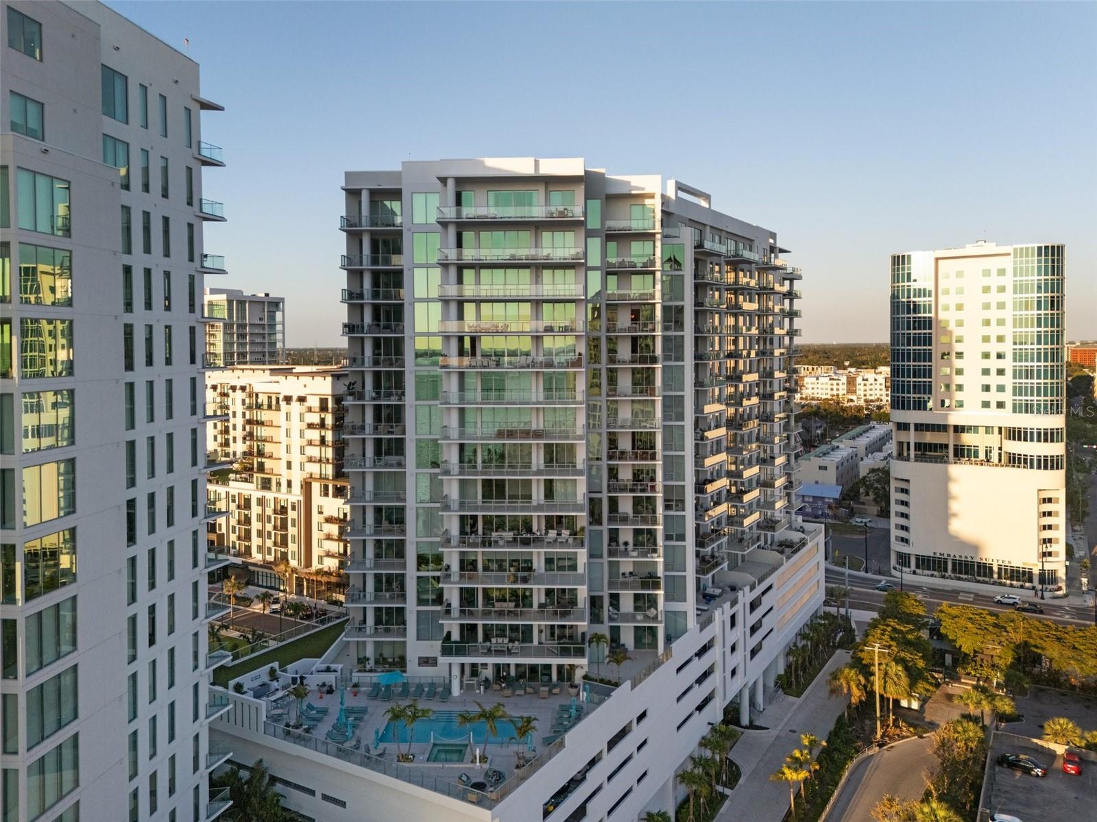 $200k Price Reduction! STUNNING LUXURIOUS WEST-FACING CORNER RESIDENCE ON THE 16TH LEVEL IN THE HEART OF QUAY SARASOTA | BREATHTAKING SARASOTA BAY & GULF VIEWS | Link to Video: https://motion-media-llc.aryeo.com/videos/01966eff-7730-7115-aa4c-e908fc41ac53 | Step into refined coastal living in this meticulously upgraded 2-bedroom + den, 3-bathroom (with soaking tub in the Primary) residence in the vibrant new epicenter of Sarasota, The Quay. Positioned on the premium west-facing corner this 2,185 sq. ft. home boasts unparalleled sunset views over Sarasota Bay and the Gulf of Mexico through floor-to-ceiling windows and soaring 10-foot ceilings that flood the space with natural light. DESIGNED FOR BOTH ELEGANCE AND COMFORT, THIS RESIDENCE FEATURES: An open-concept layout with premium porcelain tile flooring throughout, a Gourmet kitchen with upgraded soft-close European cabinetry by Italkraft, pantry pull-outs, JennAir stainless steel appliances including a convection oven, built-in oven, induction cooktop and Grohe faucets. Spacious primary suite with two walk-in closets, spa-like bathroom with dual vanities, large soaking tub, oversized shower, and linen closet. Second bedroom with ensuite bath, plus a full third bathroom and laundry room, and a den with a closet that easily converts to a third bedroom or office. EVERY DETAIL HAS BEEN CURATED FOR IMMEDIATE ENJOYMENT JUST BRING YOUR SUITCASE. Enjoy Hunter Douglas motorized blinds (blackout in bedrooms) and Custom lighting in the den, bedroom, and dining room. Additional highlights include: 2 premium location adjacent parking spaces, Climate-controlled storage locker and lightly lived in — occupied only 12 months since purchase. LOCATED IN SARASOTA’S MOST EXCITING NEW WATERFRONT DEVELOPMENT, THE QUAY, YOU’LL BE JUST STEPS FROM WORLD-CLASS DINING, SHOPPING, ARTS VENUES, AND THE MARINA. THIS IS MORE THAN A HOME – IT’S A COMPLETE SARASOTA LIFESTYLE, READY AND WAITING.