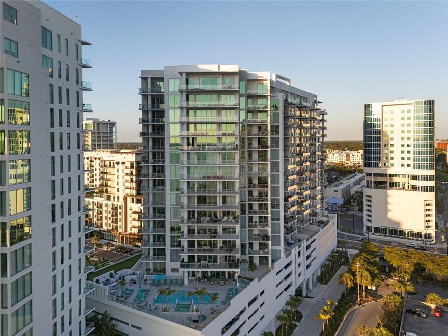 $224k Price Reduction! STUNNING LUXURIOUS WEST-FACING CORNER RESIDENCE ON THE 16TH LEVEL IN THE HEART OF QUAY SARASOTA | BREATHTAKING SARASOTA BAY & GULF VIEWS | TWO PARKING SPACES Link to Video:  https://motion-media-llc.aryeo.com/videos/01966eff-7730-7115-aa4c-e908fc41ac53 | Step into refined coastal living in this meticulously upgraded 2-bedroom + den, 3-bathroom (with soaking tub in the Primary) residence in the vibrant new epicenter of Sarasota, The Quay. Positioned on the premium west-facing corner this 2,185 sq. ft. home boasts unparalleled sunset views over Sarasota Bay and the Gulf of Mexico through floor-to-ceiling windows and soaring 10-foot ceilings that flood the space with natural light.  DESIGNED FOR BOTH ELEGANCE AND COMFORT, THIS RESIDENCE FEATURES:  An open-concept layout with premium porcelain tile flooring throughout, a Gourmet kitchen with upgraded soft-close European cabinetry by Italkraft, pantry pull-outs, JennAir stainless steel appliances including a convection oven, built-in oven, induction cooktop and Grohe faucets. Spacious primary suite with two walk-in closets, spa-like bathroom with dual vanities, large soaking tub, oversized shower, and linen closet. Second bedroom with ensuite bath, plus a full third bathroom and laundry room, and a den with a closet that easily converts to a third bedroom or office. EVERY DETAIL HAS BEEN CURATED FOR IMMEDIATE ENJOYMENT JUST BRING YOUR SUITCASE.  Enjoy Hunter Douglas motorized blinds (blackout in bedrooms) and Custom lighting in the den, bedroom, and dining room.  Additional highlights include:  2 premium location adjacent parking spaces, Climate-controlled storage locker and lightly lived in — occupied only 12 months since purchase.  LOCATED IN SARASOTA’S MOST EXCITING NEW WATERFRONT DEVELOPMENT, THE QUAY, YOU’LL BE JUST STEPS FROM WORLD-CLASS DINING, SHOPPING, ARTS VENUES, AND THE MARINA.  THIS IS MORE THAN A HOME – IT’S A COMPLETE SARASOTA LIFESTYLE, READY AND WAITING.