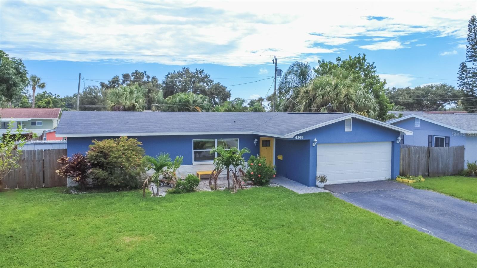 One or more photo(s) has been virtually staged. Are you looking for a move in ready home that’s conveniently located in the center of town? This 3 bed, 2 bath Holiday Park home has been fully updated and is only minutes away from tons of shopping and dining options and even the beach! Welcome to 6268 34th Ave N! Located in sought-after Holiday Park, you’ll enjoy a super convenient location all in a well-established neighborhood with nearby parks and beautiful mature trees. Step inside to find an open concept and split floor plan layout with plenty of storage, and terrazzo flooring that brings in that mid-century modern charm. The living room is spacious with large front windows that let in tons of natural light. For ideal entertaining, the living room opens up to the kitchen which features granite countertops, stainless steel appliances and an island for even more work space. The eat-in dining area gives you the perfect set up to host dinners and parties with large french doors that lead outside. The screened-in patio has plenty of space for outdoor furniture and with the expansive backyard you’ll have that perfect indoor to outdoor lifestyle. The layout features a split plan with a generously sized primary bedroom boasting a walk-in closet and renovated attached bathroom with a beautiful tiled shower. Across the house, both guest rooms and guest bathroom are spacious and offer plenty of storage to complete your family and lifestyle needs. In the backyard you’ll enjoy an extra living space already prepared for you with a/c and power to turn it into the she-shed, man cave or art studio of your dreams! You’ll also appreciate the curb appeal, mature landscaping and fully fenced in yard, as well as a rare two car garage to store all your cars and toys. This home also has fully paid off solar panels which takes your monthly power bill down to only $36! In addition, the roof, hvac system and electrical have all been updated in recent years. Owners experienced no flooding in last year’s storm season. Close to nearby Tyrone Mall and Crossroads shopping centers, you’ll have all the local shops and dining options imaginable. With only a short car ride to Walter Fuller Park and easy access to other area waterfront parks and our beautiful beaches, you’ll have everything you need right at your fingertips. You can simply move right in and start living that Florida lifestyle today!