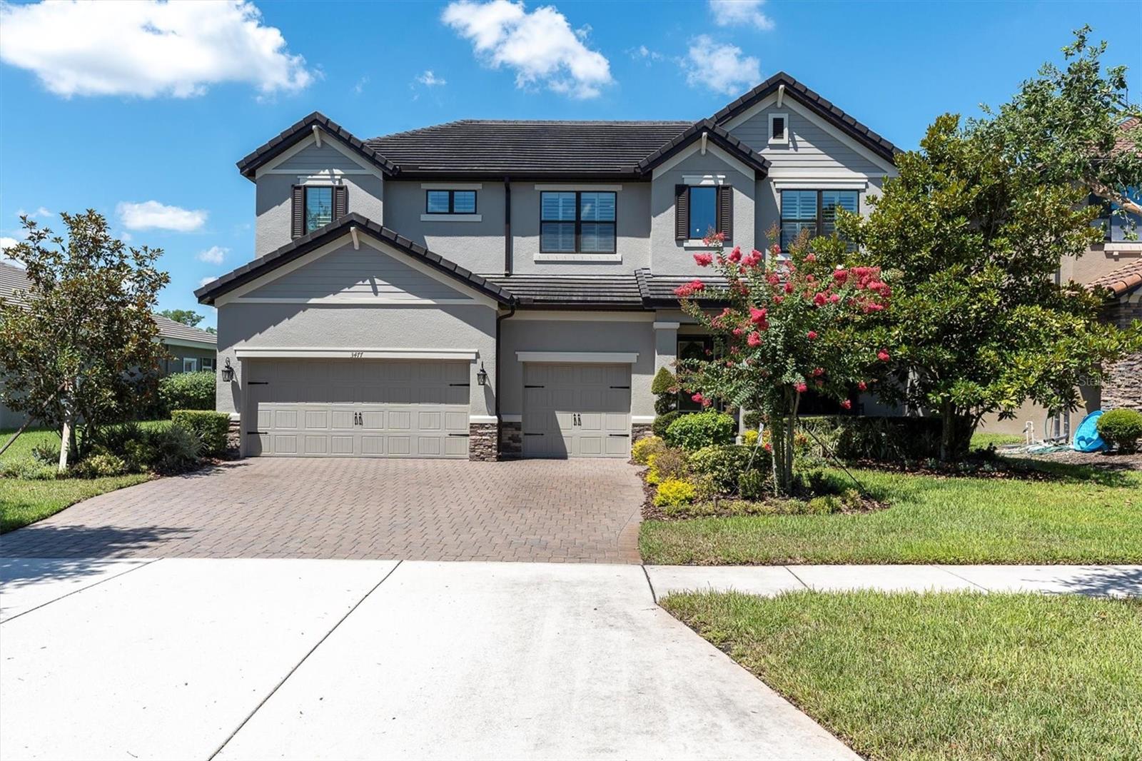 BACK ON MARKET ~ BUYERS FINANCING FELL THROUGH. SHOWCASE HOME ON POND & CONSERVATION IN DESIRABLE STARKEY RANCH! Well Appointed MI Homes Santina II offers 5/3/3 + bonus rm up & down w/ 16 x 28 Pebble Tec pool & panoramic screen located on a private 65’ conservation/pond lot w/ stunning west facing nature views located in Whitfield Preserve in the highly sought-after community of Starkey Ranch. Custom designed in 2017 w/ over 65K in luxurious upgrades w/ builder & 186K after market, this intelligently positioned & popular open floor plan offers functional living space for entertaining & everyday life. Attractive exterior has exceptional curb appeal thanks to the tile roof, stone detail, shutters, Hardie Siding, paver driveway, manicured landscaping & a welcoming front porch. Entering the foyer through the frosted glass inlay front door, the soaring ceiling, custom board & batten & stylish light fixtures capture your attention. A neutral Provenza MaxCore waterproof Luxury vinyl fl is located throughout most of the home creating a consistent flow. Noteworthy upgrades include Hunter Douglas Plantation shutters, Crown Molding, 8’ doors & freshly painted exterior. As you enter the foyer, to the right is the formal dining rm/office accented by chandelier & millwork. The open floor plan unfolds offering a cozy gathering place for entertaining & relaxing. The living room is anchored by a ceiling fan, Crown Molding, electric fireplace w/ Mantel & Hearth, board & Batten & a breathtaking view of nature. The luxurious kitchen will impress w/ White 42’ Shaker wood cabinets & Drawers accented w/ crown molding are complimented by gold hardware blend beautifully w/ Silstone Dove White Quartz counters. Spacious island seats 3 bar stools comfortably illuminated by 2 Pottery Barn Pendant Lights. Island provides additional storage, a stone deep basin sink, Moen Gooseneck faucet & Reverse Osmosis filtered water. Upgraded Stainless appliances include Samsung refrigerator, 5 burner Bosch gas range, Double ovens, new microwave & newer Bosch Dishwasher. A casual café dining space with chandelier & pretty views is conveniently located close to the kitchen. A fully remodeled guest bath w/ walk in shower & bedroom 5 are located on 1st fl. A pool room, currently purposed as a gym, provides multifunctional space. Ascend the wood stairs to the 2nd story where the spacious owners retreat offers ample room for furniture and a sitting area w/ ceiling fan. Luxurious selections in fully remodeled ensuite impress w/ his & hers quartz counters, cabinets, frameless walk-in shower, soaking tub & walk in closet w/ custom organizers. A lg bonus rm will be useful space to gather for movie night. Well-sized Br 2 offers chair rail accent & natural light while Br 3 and 4 are located down the hallway with an adjacent full bath w/ tub shower combo & dual sinks. A covered lanai, overlooking the private trees & pond will be a nice area to dine alfresco & view wildlife such as deer & birds. Enjoy west facing views & evening sunsets against nature’s finest backdrop in your fully fenced backyard. Relax or splash in the 16x28 pool w/ sunshelf, bubbler, LED lights & waterfall w/ panoramic screen. *Garage storage racks* Water softener & Reverse Osmosis* UV light in AC* Starkey Ranch offers Magnet K-8 school, 3 pools, playgrounds & 20 miles of trails. Easy access to Restaurants, Publix, beaches & Tampa Airport. Experience the grandeur in person & make this exquisite home yours.