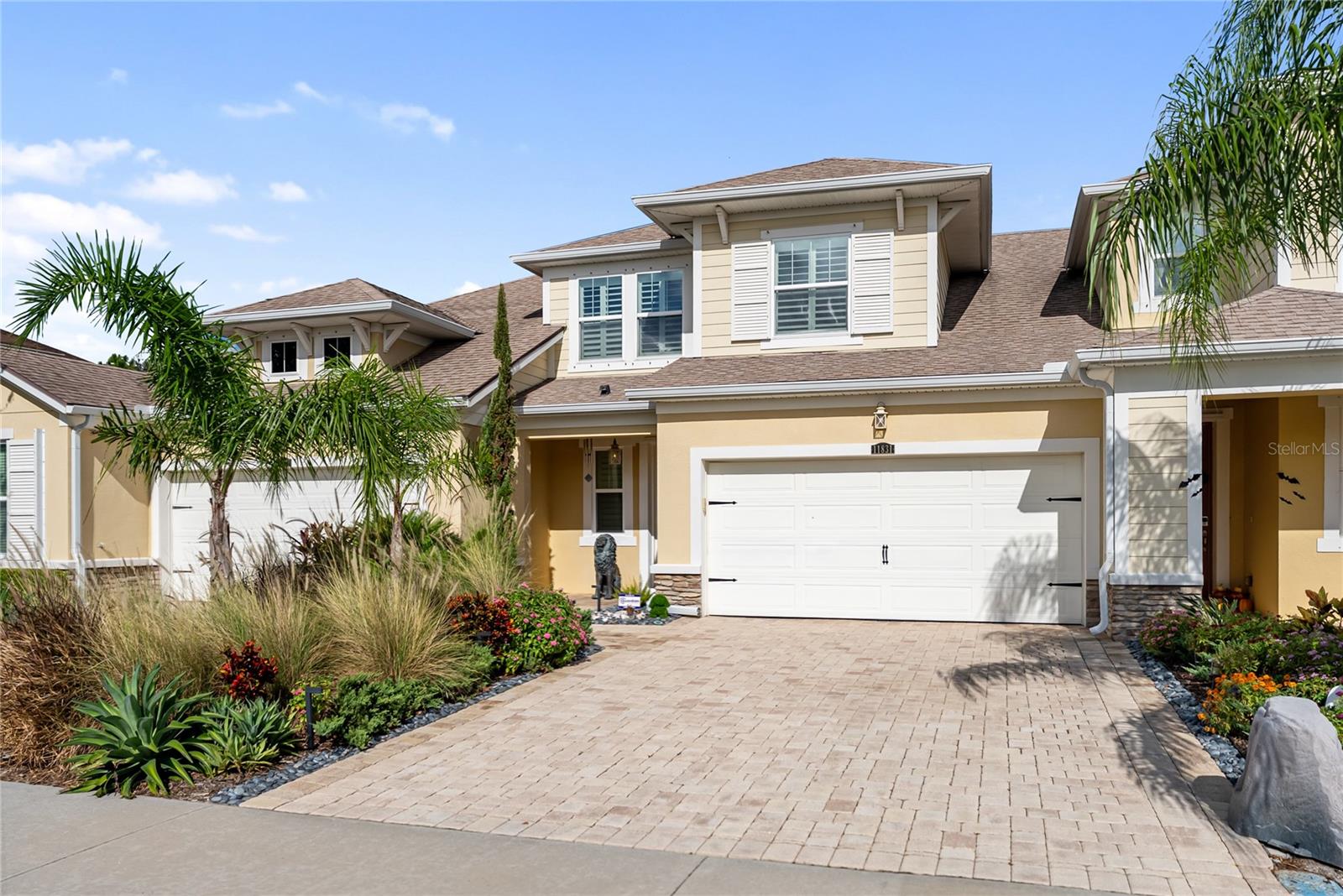 Welcome to this exceptional 3 bedroom, 3 bathroom townhome in the coveted Harmony at Lakewood Ranch, where refined design and effortless living combine to create the ultimate Florida lifestyle. From the moment you step inside, you’ll be greeted by soaring ceilings, an abundance of natural light, and an open-concept floor plan that blends elegance with everyday comfort. The gourmet kitchen is a true showpiece, featuring granite countertops, stainless steel appliances, custom cabinetry, a stylish backsplash, and a large center island that opens to the dining and living areas—perfect for hosting gatherings or enjoying quiet evenings at home. The living room is highlighted by a dramatic double-height ceiling with a balcony overlook from above, creating a sense of grandeur while maintaining warmth and livability. Sliding glass doors lead to your private screened lanai, where lush landscaping and peaceful views provide the perfect setting for morning coffee or evening relaxation. Upstairs, the spacious primary suite is a serene retreat with a spa-inspired bathroom, dual vanities, and generous walk-in closet space, while additional bedrooms offer versatility for family, guests, or a home office. Every detail, from designer light fixtures and custom finishes to the carefully chosen flooring, enhances the sophistication of this home. For added convenience, the property also includes a built-in alarm system and a Tesla charger. Harmony at Lakewood Ranch offers resort-style amenities including a sparkling community pool, clubhouse, fitness center, and playgrounds, all surrounded by manicured grounds that reflect the community’s commitment to quality and lifestyle. Ideally located, you’ll enjoy easy access to Lakewood Ranch’s world-class shopping, dining, top-rated schools, championship golf, medical facilities, and the award-winning Gulf Coast beaches just a short drive away. This home is more than just a place to live—it’s a lifestyle, offering the perfect blend of luxury, convenience, and community in one of America’s top-selling master-planned neighborhoods.