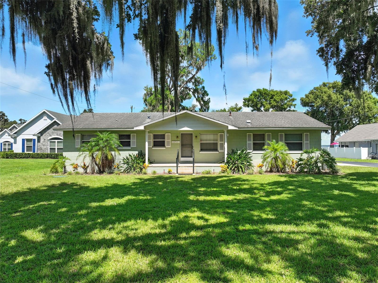 If you are looking for LAKEFRONT on the Chain of Lakes, here is a diamond in the rough. 2 homes, private dock with mature shady trees all on an acre of land with 125' lake frontage. The main home is a 2 bedroom /2 bath with a great enclosed lanai for those relaxing times while enjoying the water views. The cottage has 2 bedrooms & 1 bath and located closer to the lake. This property is in the COUNTY and NO HOA. New central a/c in main house 2024. Located only 5 minutes to the Hospital and close to businesses & shopping on Hwy 441. Great possibilities with this property. Live in one home & rent the other or maybe renovate & enlarge to get your personal dream home. You might want to take a closer look at this property.