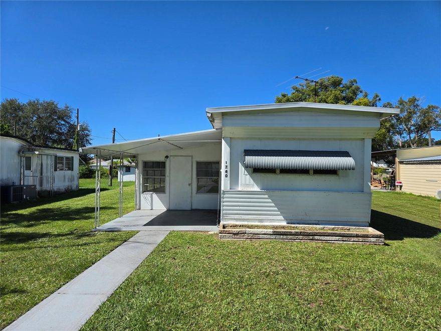 Discover this affordable two-bedroom, one-bathroom mobile home centrally located in St. Cloud. This home is not located inside of a mobile home park and there is NO lot rent!  Step inside to find stylish vinyl plank flooring throughout the main living areas and carpet in both bedrooms. Enjoy the spacious Florida room—perfect for year-round relaxation or entertaining guests. Convenient alley access leads to the rear-entry carport, offering both privacy and ease. A detached, concrete-block storage shed provides plenty of space for tools, hobbies, or workshop needs. Washer and dryer hookups are conveniently located on the rear porch. Don’t miss your chance to make this inviting home yours—schedule a private showing today!