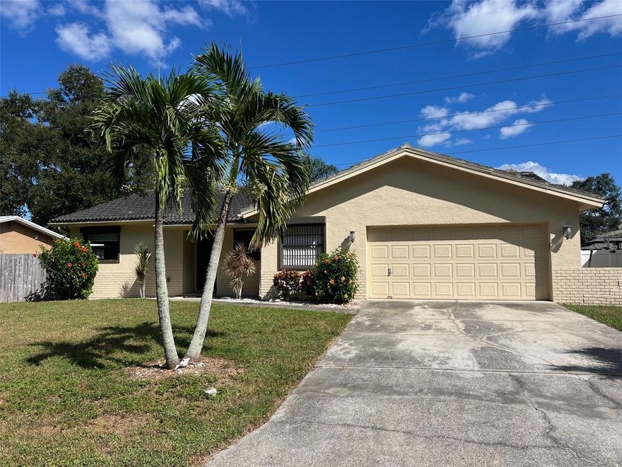 Welcome to this well-maintained 3-bedroom, 2-bathroom home with a 2-car garage, located in the heart of Palm Harbor. This spacious property includes a separate 80x38 lot directly across the streeet, ideal for storing a boat, RV, work vehicles, or extra parking. Inside, you'll find an oversized living room with wood-look tile flooring, a large master suite with an updated bathroom featuring a glass-door shower and subway tile, plus a split floor plan for added privacy. The eat-in kitchen offers plenty of storage. Enjoy the enclosed sunroom and a large fenced backyard with a double gate, perfect for outdoor living or storing toys. Additional perks include no HOA, no flood insurance required, and hurricane shutters throughout. Walk to Publix, Walgreens, and public transit. Just minutes to beaches, Pinellas Trail, Dunedin Causeway, shopping, and dining.