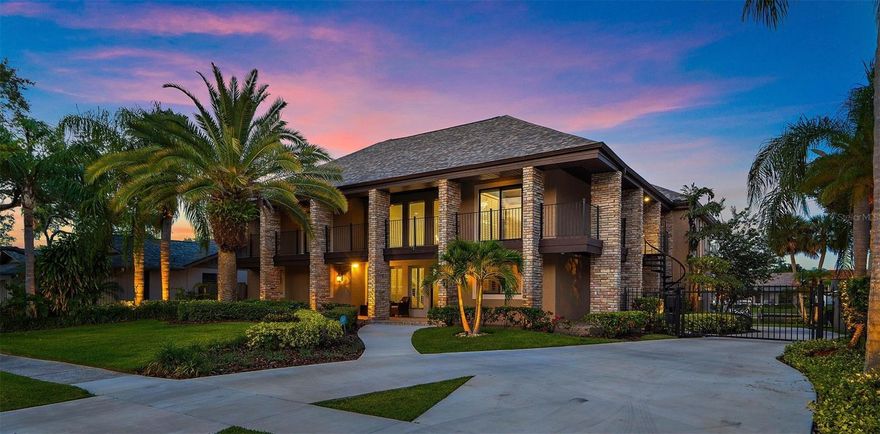 Under contract-accepting backup offers. Introducing an amazing waterfront home in the private, gated community of Sweetwater Subdivision. This waterfront setting has protected deep water canal access to the lively waters of Tampa Bay. Step inside this expansive home featuring a spacious floor plan with 5 bedrooms and 4 baths offering ample space for a large family to spread out comfortably. The charming exterior, with a new roof installed in 2023, welcomes you with two levels of covered porches, while the grand foyer entrance with soaring ceilings, serves as the centerpiece between the formal living room and formal dining room. Flowing effortlessly from the foyer or dining room, you'll discover the heart of this lively home: a family room, huge kitchen, and informal dining area, all designed to facilitate seamless entertainment. This space boasts three oversized granite counters including a huge semi-circular island designed for spacious seating. Here, your friends and family can relax while the talented chef in your family creates culinary masterpieces.  Additional features such as plenty of cabinet space, built-in desk with storage, custom built-in wine display, dual convection ovens, and a 12' bar counter allow for ample room to accommodate all your entertaining. Currently serving as a home office, the first-floor bedroom with laundry and full bath provides versatility and convenience.  Ascend to the upper level to find 4 bedrooms, including the main suite, a junior suite, two guest rooms connected by a Jack and Jill bath, and a game/media room completing the well-designed floor plan. The main suite is a haven of relaxation, boasting a dreamy bath with a modern, deep soaking tub, an oversized shower, two separate vanity areas, and a huge walk-in closet with custom organizers. From the bedroom and bath, you can enjoy breathtaking water views, while a private porch offers a bird's-eye perspective of the rear of the home's pool and waterfront. Situated on one of the largest lots in the neighborhood, this residence offers exceptional backyard space in addition to the large pool and deck area surrounded by tropical landscape, lush green grass, and ample room for outdoor play. The rear garage is accessible via a private, gated, pull-around drive for parking, complemented by an electronic gate that ensures secure entry to the back driveway with the added benefit of keeping your pets and children safe. The pool, newly constructed in 2022, boasts numerous upgrades, including wireless controls, a sun deck, waterfall, and fountain features, as well as LED color-changing lighting and bubbling whirlpool seating swim out shelves. A covered porch beckons you to relax and observe the pool's activities, while an oversized dock and remote-controlled boat lift provide yet another entertaining space, perfect for enjoying the company of visiting manatees, dolphins, and abundant fishing opportunities. With 6-7 feet of water depth at low tide, larger boats can be moored right at your new home. Just minutes from Berkeley Preparatory School, Tampa International Airport, and International Plaza Mall this home is convenient for travel and the best of shopping. Make this your new home and get started enjoying the vibrant, Florida waterfront lifestyle and immerse yourself in the countless attractions of Tampa Bay.