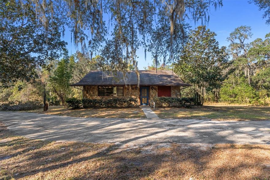 Agricultural Residential  Zoning and exceptionally private. No dirt roads from the highway to your doorstep with over 300 feet of blacktop driveway. Natural Florida beauty on this 4.22-acre property with a spring-fed creek. This rare two-story home features an upper-level entry with a primary suite, two huge balconies,  living room, kitchen, and dining area overlooking the wooded landscape. The lower level—accessible by stairs includes a second primary suite, an oversized family room, and a laundry room, offering excellent flexibility for guests or multi-generational living. Zoning allows for outbuildings and animals.

Located in a peaceful area of Brooksville known for its large acreage homes, rolling terrain, and quiet country surroundings, this property provides a true sense of space while remaining convenient to I-75, local parks, nature preserves, and everyday amenities. Enjoy easy access to Croom Wildlife Management Area, hiking/biking trails, farms, and outdoor recreation, all within a short drive.