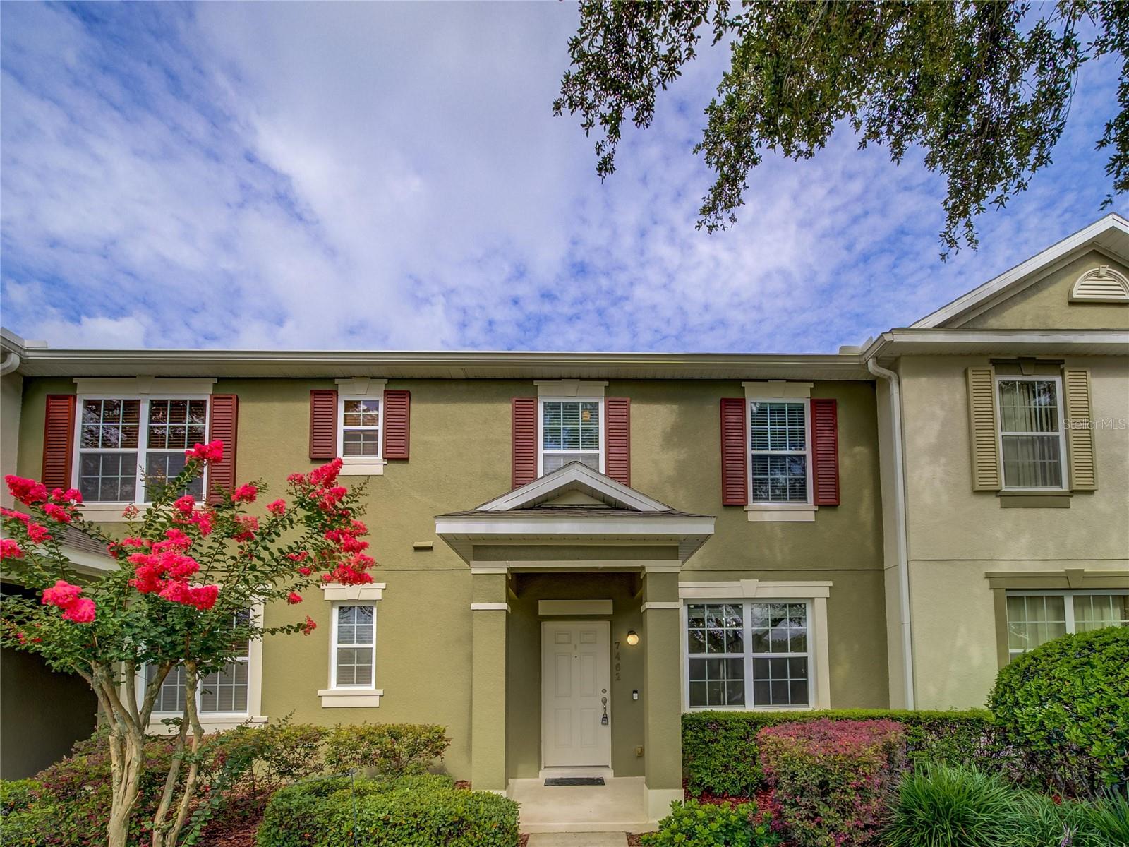 Move in ready 3/2.5 Townhome in Windermere! New roof 2024. Rear entry 2 car garage. All stainless-steel fridge, stove, microwave and dishwasher and solid surface counter tops. Versatile all ceramic tiled 1st floor plan with formal dining room or use as front office. Open kitchen to rear great room that opens to covered screened private patio and fenced yard. All bedrooms up, Primary bedroom features ceramic tile floor, fan, 8'x5' walk-in closet, dual sinks and garden tub in en-suite bath, secondary bedrooms have carpet. Energy efficient double pane windows. Community pool and clubhouse, playground, and trails nearby all at affordable HOA fees. Convenient to shopping and attractions and no neighbors across the street. One or more photos has been virtually staged with A-I technology.