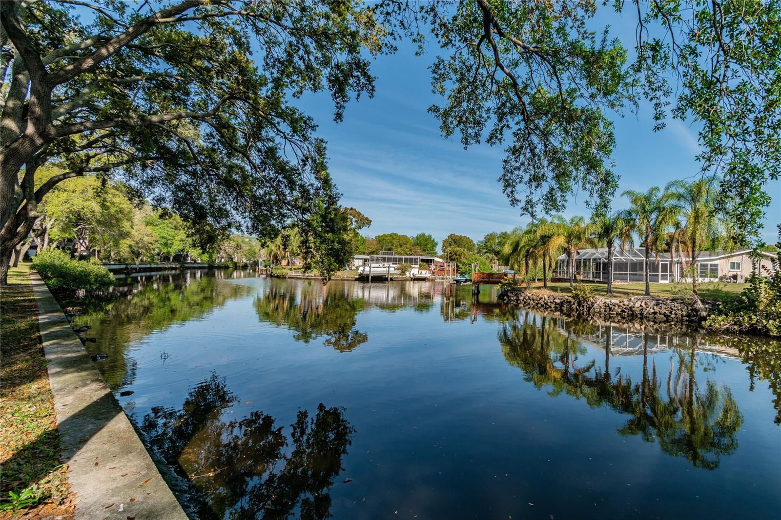 WATERFRONT LIVING, FULLY RENOVATED & GREAT LOCATION IN TAMPA! A very comfortable and open floor plan, your reserved parking space is right in front of your door, and your bedroom view is absolutely gorgeous, because it's direct WATERFRONT and WATERVIEW. Your screened-in lanai faces north, and you will get to come home at the end of the day, sit out in the covered and screened lanai without the sun beating in on you and enjoy the boats, birds, manatees, porpoise and fish that frequent the waterway. The river/canal is fed from freshwater lakes and Old Tampa Bay, and with change of tides, is a mix of fresh and saltwater, making it brackish. One of the pools, tennis courts, racquetball courts, boat and trailer parking and property manager's office is on the far west side of the property. Some decks/docks with benches and grills nearby are built within another common park area (just to the north a few hundred feet from your condo), over the seawall. Unit has dishwasher and a full laundry facility is located nearby on property. Centrally located: Tampa International Airport is only 6 miles away, Clearwater Beach is 20 miles away, Downtown Tampa is only 11 miles away, and Downtown St. Pete is only 23 miles away. An easy commute to almost anywhere in the Tampa Bay area.