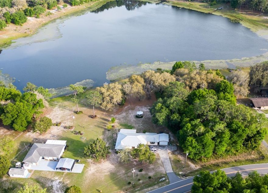 Lakefront living with built-in income potential! This well-maintained home sits on a landscaped 1.19-acre high and dry lot in a quiet neighborhood just minutes from downtown historic Melrose. 3 bedrooms, 3 full bathrooms, an open flow, tons of storage, and a fully screened patio w/ hot tub. Additionally, there is a 900-sqft semi-finished basement with drywall, electrical, and plumbing. Use it for massive storage, finished into a private office space, etc. Separate storage area for lawn mowers and yard tools plus a 1-car garage and ample additional driveway parking. A full efficiency apartment with kitchen and full bathroom is currently rented for almost $1,000/MO on a short-term lease. Perfect for passive income, the perfect in-law suite, or a guesthouse. All of this in a prime location less than 30 minutes to Gainesville and just 5 minutes up the road to the almost 6,000-acre Lake Sante Fe public boat launch! Seller financing possible. Welcome Home!