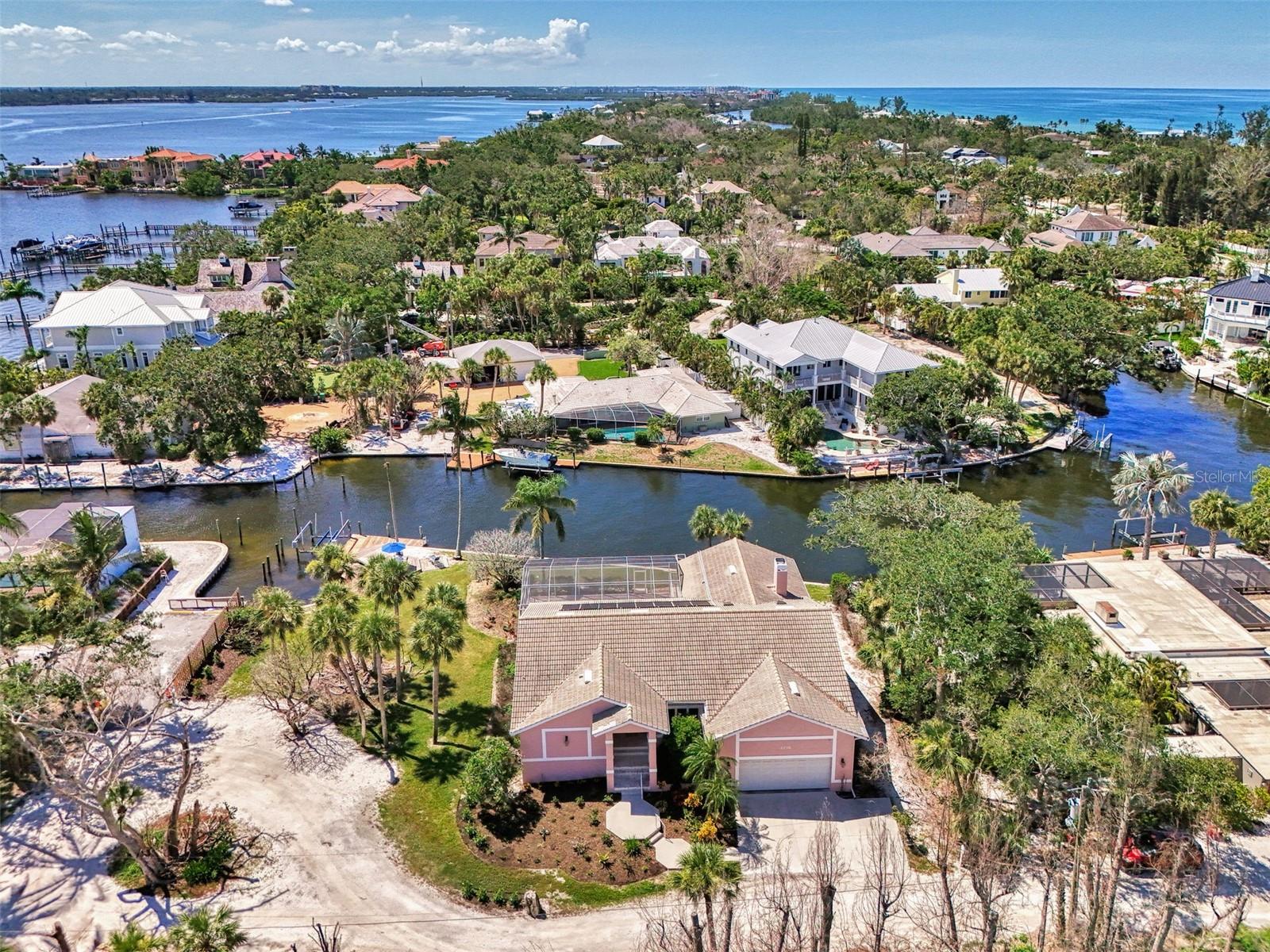 Siesta Key Waterfront Canal Home with easy access to the Intercoastal Waterway with only one house from the open Bay. Nestled in a tranquil and highly desirable location with a private setting. Situated on an expansive lot with a wide canal. Amazing views of Sarasota Bay! Discover this lovely 3 bedroom 2 bath home that sits up high and stays dry! Floor plan designed for entertaining! Open & spacious rooms with high ceilings in Living room / Dining room, Kitchen /Family room. Master bedroom has a sitting area that could be used for an office, den or hobby room. Relax on a cooler evening with a wood burning fire from your family room looking down at the Bay. Watch the boats as they pass by. The outdoor space is equally impressive with pool and spa- nice for cooling off on those warm days!. Calling all Boat & Water Lovers the property comes with a boat lift, water & electricity to the dock along with a swim ladder and sundeck. Fish, Swim, Kayak, or Paddleboard from your backyard. Upgrades- Roof- 5 yrs old, AC 3 yrs old, All Impact Windows & Sliders and 2 Car Garage. A wonderful opportunity to own a piece of Siesta Key Waterfront!