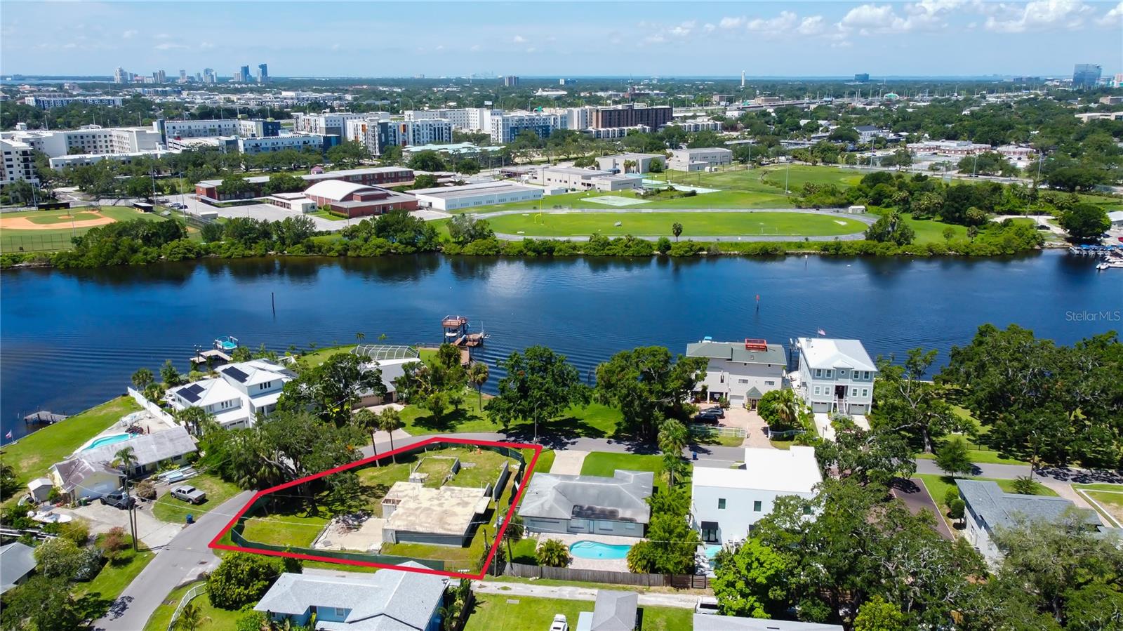 This is the perfect opportunity to own prime property in the Ridgewood Park district of Tampa. This property sits on an oversized lot which would give a homeowner or a developer a canvas to build a custom home or potentially a multifamily development. There are three contiguous properties, this one included that are available for sale by the same owners. All properties together would provide an investor or developer the chance to seize an opportunity to develop on a significant stretch of riverfront land that offers build ability and zoning potential-not to mention stunning views of the Tampa skyline and Hillsborough River. This property is very central to everything Tampa has to offer such as eateries, schools, Armature Works and just a quick travel to the downtown area.