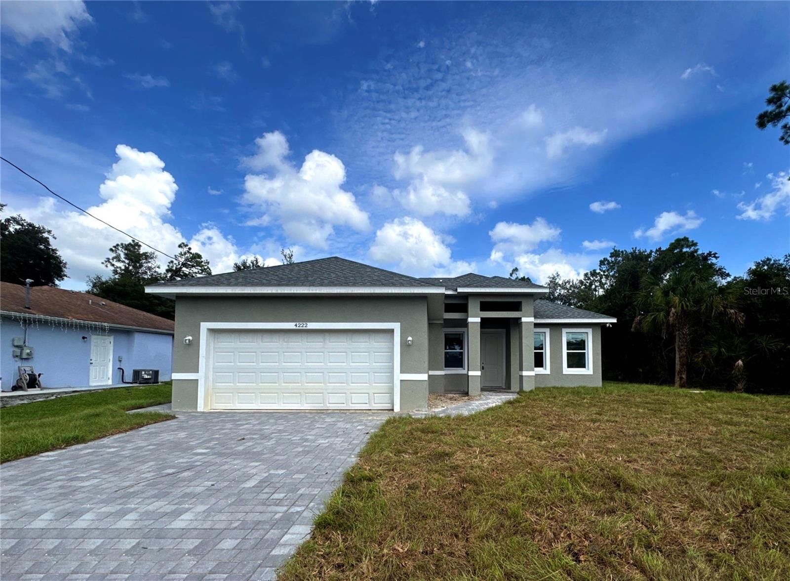 Under Construction. PUBLIC WATER CONNECTION. Beautifully designed home with 1,840 sq ft of living space, featuring 3 spacious bedrooms, 2.5 bathrooms, and a 2-car garage. This open-concept layout connects the kitchen and living areas, making it ideal for family gatherings and entertaining. The kitchen is equipped with high-quality appliances and a central island for easy meal prep. A spacious garage comfortably accommodates two vehicles, with additional storage space. With a total area of 2,653 sq ft, including an inviting 82 sq ft entry, a 441 sq ft garage, and a relaxing 290 sq ft lanai, this home offers both functionality and comfort to meet all your lifestyle needs. Additional features include a SMART KEY system for enhanced security and the peace of mind that comes with a 2-10 HOME BUYERS WARRANTY. Don’t miss out—schedule a showing today!