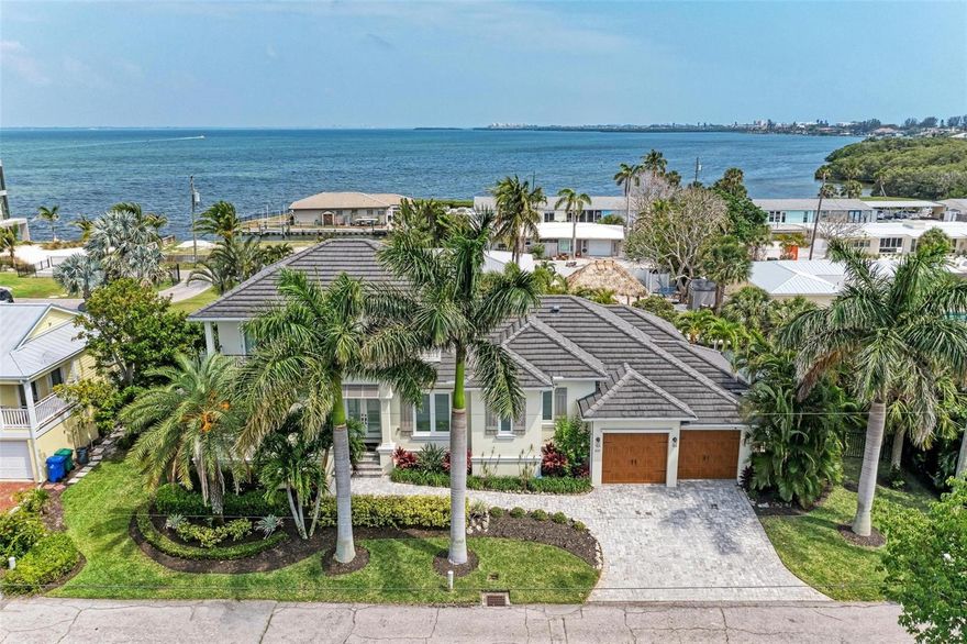 Discover unparalleled luxury, comfort, and coastal charm in this stunning canal-front pool home, built in 2015. With 120 feet of pristine canal frontage and a 10,000lb boat lift, this property is a true boater's paradise. Enjoy the ultimate waterfront lifestyle with deeded beach access nearby, seamlessly blending elegance with convenience. Spanning just under 2,500 sq ft of meticulously designed living space, this fully furnished coastal-themed retreat features 4 bedrooms, 3 bathrooms, and a bonus living area on the second level. You're greeted by lush tropical landscaping and a charming paver driveway, enticing you to explore further. Stepping through the inviting French doors, you'll be captivated by the sparkling pool and peaceful canal views that unfold before you. Abundant natural light, tray ceilings, hardwood floors, plantation shutters, and an open floor plan create a seamless environment perfect for entertaining. The heart of this home is the gourmet kitchen, a chef's delight with a large island and a suite of stainless steel JennAir appliances, including a gas range. The kitchen effortlessly flows into the living area, where a corner meeting sliding glass door creates a harmonious indoor/outdoor living experience. Imagine poolside BBQs and gatherings on the spacious lanai, complete with an outdoor kitchen and ample dining space, all while enjoying serene water views and the inviting pool. For boating enthusiasts, the 10,000lb boat lift is a standout feature and is just steps from your back door, making accessing the water effortless. Escape to the luxurious primary suite, offering direct pool access for morning swims that become a delightful routine. Indulge in the spa-like ensuite, complete with a soaking tub, porcelain tile shower, private water closet, and dual vanities, creating the perfect ambiance for starting your day in luxury. The thoughtfully designed floor plan places a second bedroom and bathroom, which doubles as a pool bath, on the opposite side of the home. Upstairs, the second living space with a wet bar offers access to two balconies, providing partial views of Sarasota Bay and beyond. Two additional bedrooms and a third bathroom complete this level, offering ample space and added privacy for family and guests. Located just three lots from the canal opening to the Intracoastal Waterway, this property provides quick and easy access to Sarasota Bay, the Intracoastal, and the Gulf of Mexico. The neighborhood's deeded beach access offers miles of sandy shores for morning walks, afternoon lounging, and evening strolls. Situated on the highly sought-after north end of Longboat Key, this home is perfect as a primary residence, second home, or investment property. Minutes away from renowned restaurants, scenic parks, and close proximity to Anna Maria Island, Bradenton, and Sarasota, this home is a smart choice for those seeking an exceptional island lifestyle. This home has been used as a short term rental and has a proven track record of reservations.