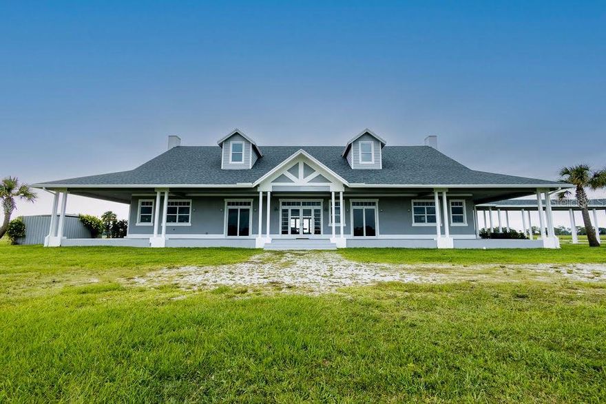 Own one of the largest farms in Martin County Ranches. The Big G is a remarkable 7, 425 SF (3, 400 SF under air) estate home on 21.3 acres offering the ultimate in privacy. Gated entrance within the gated community, brings you to a show stopping home at the end of the driveway. This ranch home boasts 3 BR, 3 1.2 baths with vaulted beamed ceilings, separate office, open living area, fireplace, kitchen and separate dining area. Traditional Florida wrap-around porch, outdoor kitchen and gas fire pit. Swimming pool overlooking wood deck on the edge of the lake. A true nature lover's haven can be your new family home.