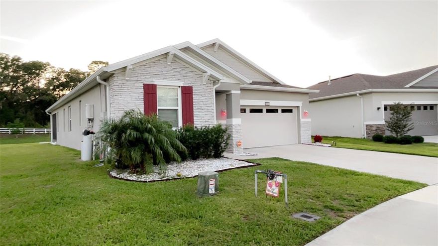 Stunning modern single story residence, nestled in Okahumpka, Florida, this exquisite 3 bedroom, 2 bathroom, 2 car garage single family home, built in 2022 is located just 12 minutes from downtown Leesburg and local businesses, schools and local churches. This ready move-in contemporary home includes an open concept with high ceilings and a modern cool gray color which accentuates the interior walls, an upgraded tech space, a spacious carpeted, cozy owner's primary bedroom with spacious master bathroom, 2 additional immaculate carpeted bedrooms, an additional present day guest bathroom, modern laminate floors in all open areas, gorgeous quartz counter tops, an eye catching spacious great room for family relaxation, a separate full dining room with bright lighting, a modern kitchen equipped with stainless steel energy saving appliances, elegant trendy cabinets, a versatile kitchen island with advanced water faucet system, including contemporary bright lighting, easily accessible double sinks and efficient dishwasher. A separate comfortable laundry room houses the washer and dryer. From the moment you arrive, the home's curb appeal speaks volumes with pristine landscaping. This beautiful home also includes front exterior lighting, a spacious screened porch lanai, an exterior irrigation system, roof rain gutters, a spacious driveway and attached 2 car garage, an advanced gas water heater and a whole house water softener system. Call today to schedule your own private showing.